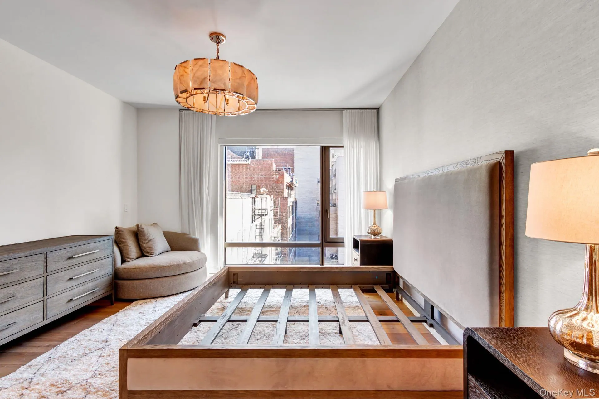 Bedroom featuring wood finished floors, a chandelier. Bedroom featuring wood finished floors, a chandelier.