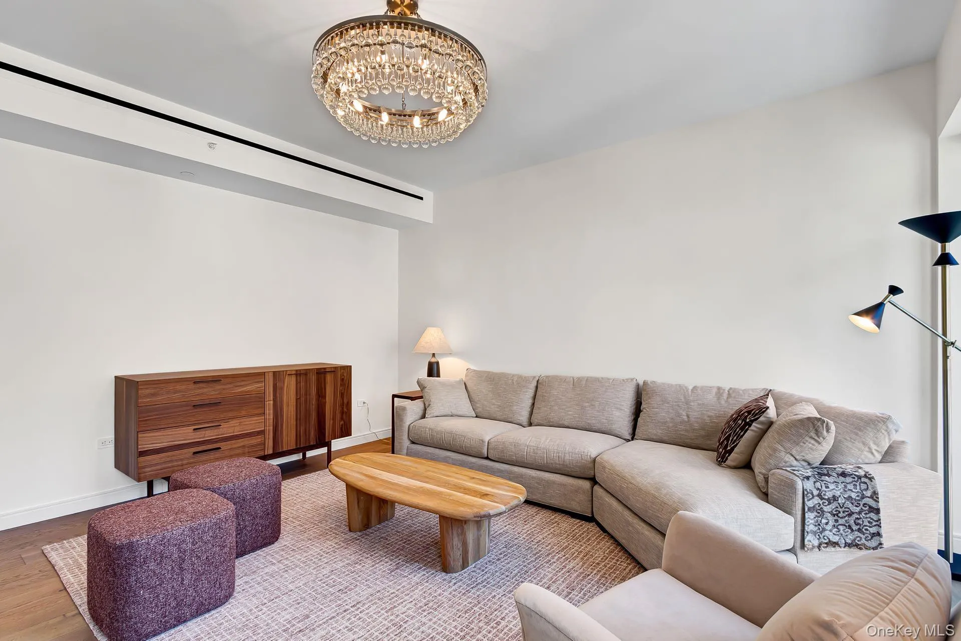 Living room with wood finished floors and a chandelier Living room with wood finished floors and a chandelier