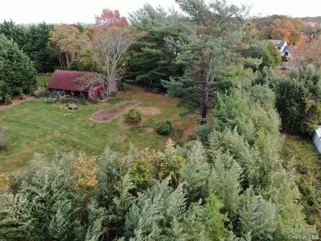 Aerial view of property's location with a heavily wooded area Aerial view of property's location with a heavily wooded area