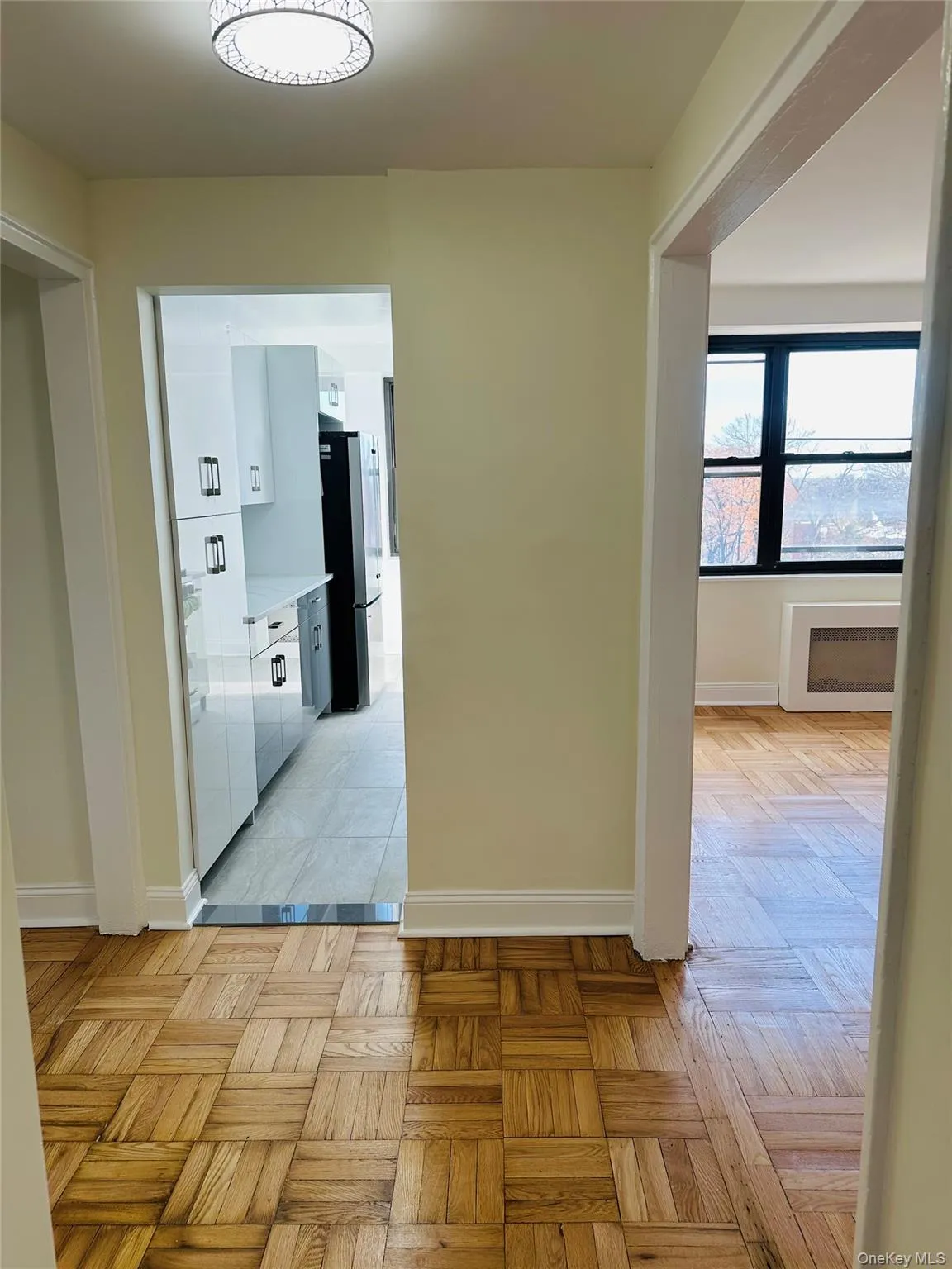Hallway with baseboards and radiator heating unit Hallway with baseboards and radiator heating unit
