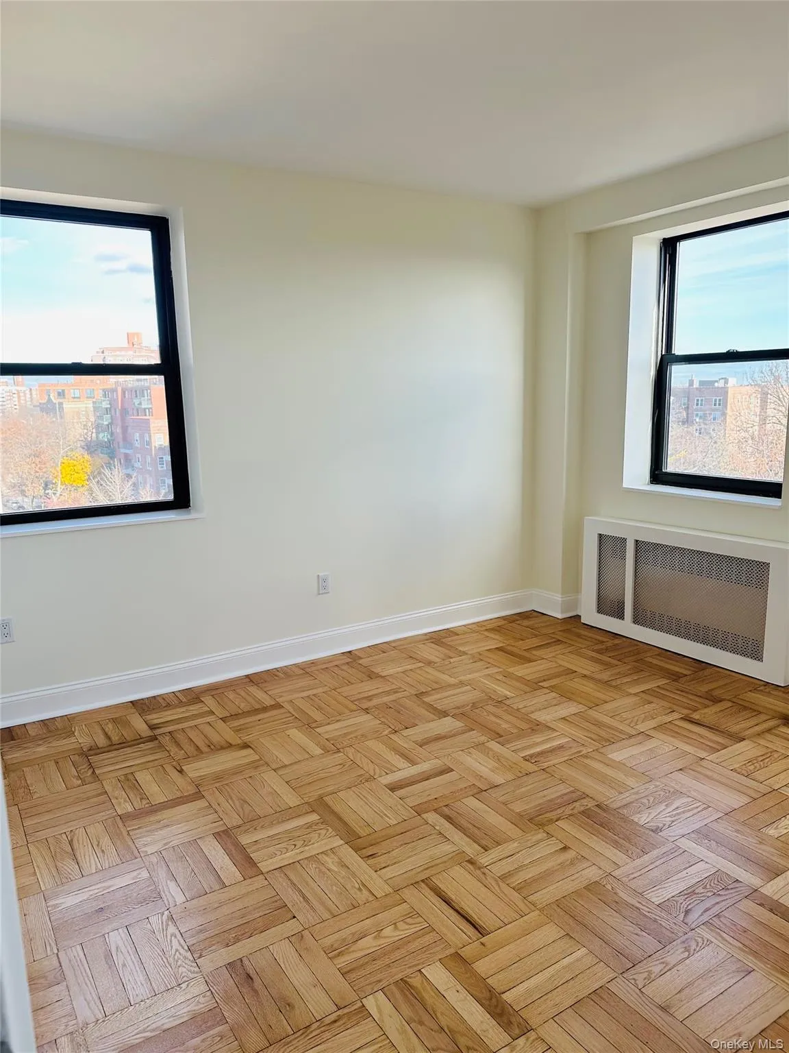 Spare room with radiator heating unit and healthy amount of natural light Spare room with radiator heating unit and healthy amount of natural light