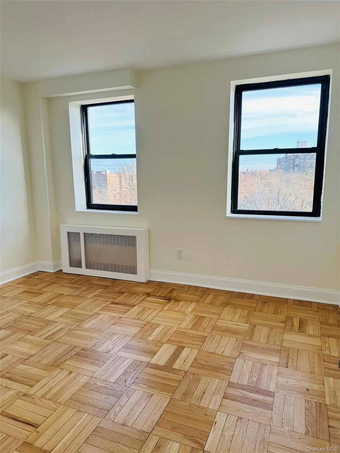 Spare room featuring radiator and baseboards Spare room featuring radiator and baseboards