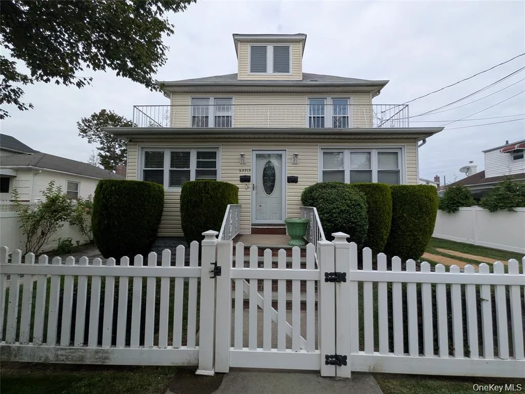 Traditional style home featuring a gate and a fenced front yard Traditional style home featuring a gate and a fenced front yard