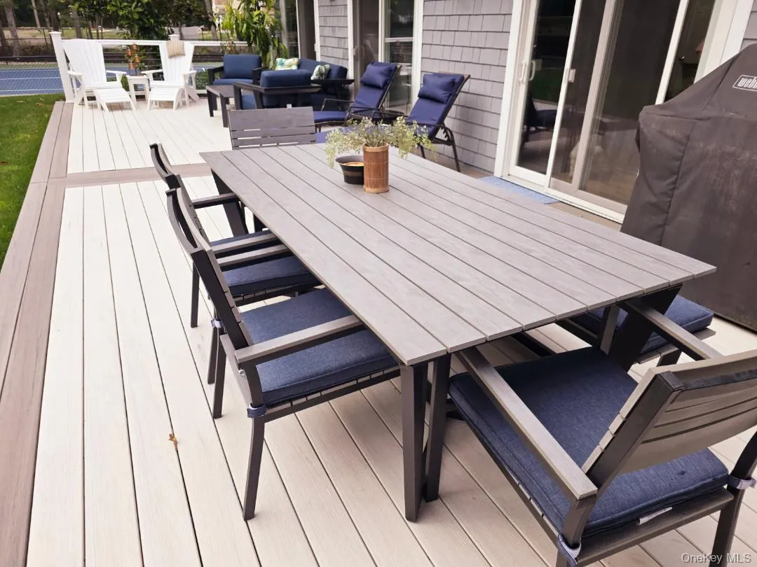Wooden terrace with outdoor dining area, area for grilling, and outdoor lounge area Wooden terrace with outdoor dining area, area for grilling, and outdoor lounge area