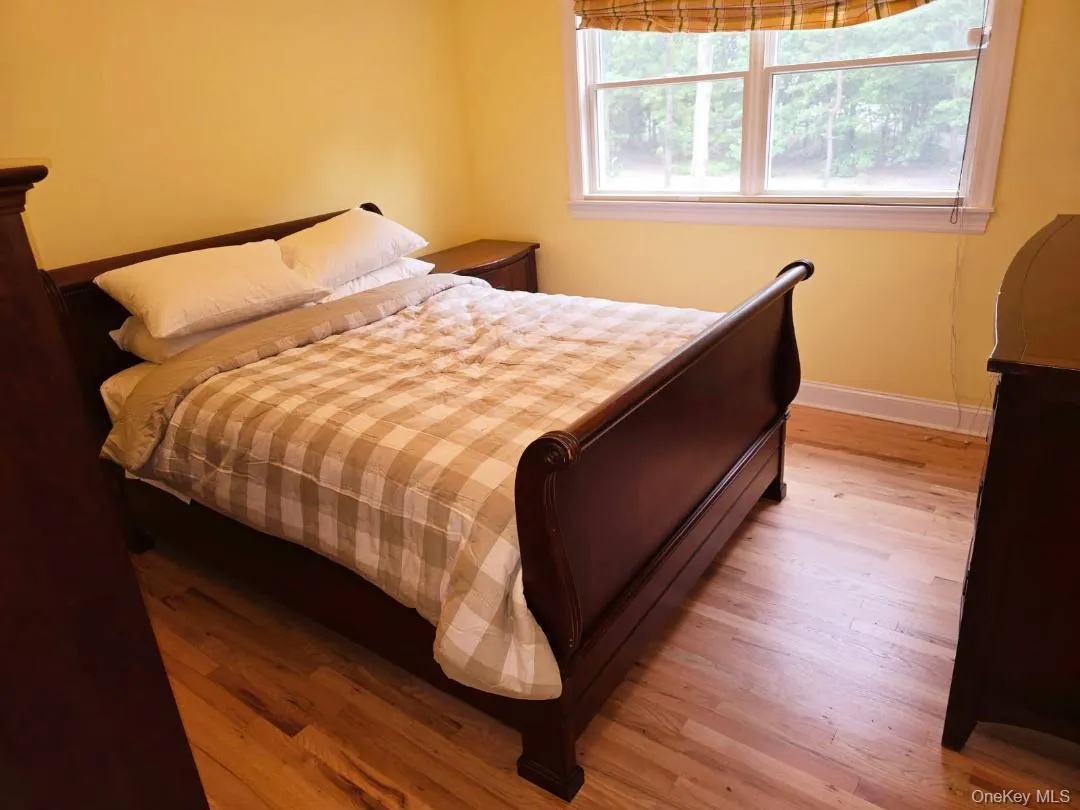 Bedroom with light wood finished floors and baseboards Bedroom with light wood finished floors and baseboards