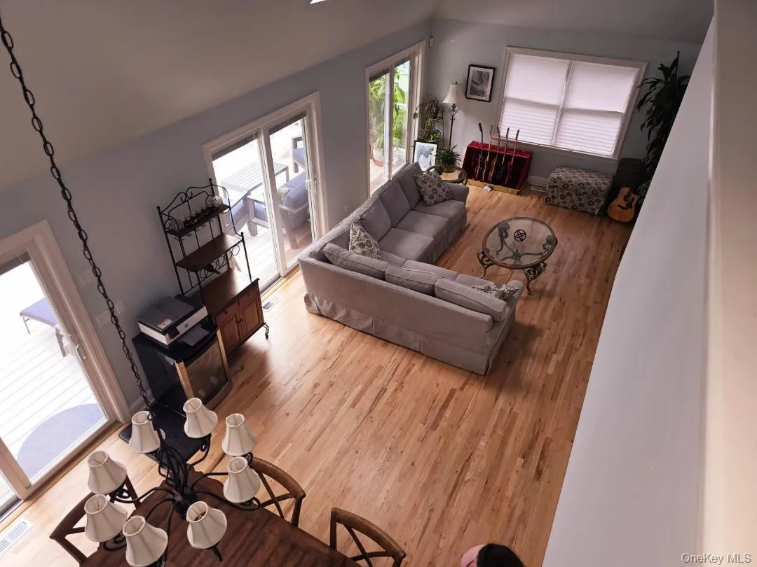 Living area with light wood finished floors and vaulted ceiling Living area with light wood finished floors and vaulted ceiling