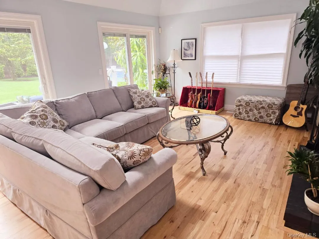 Living area with light wood finished floors and vaulted ceiling Living area with light wood finished floors and vaulted ceiling