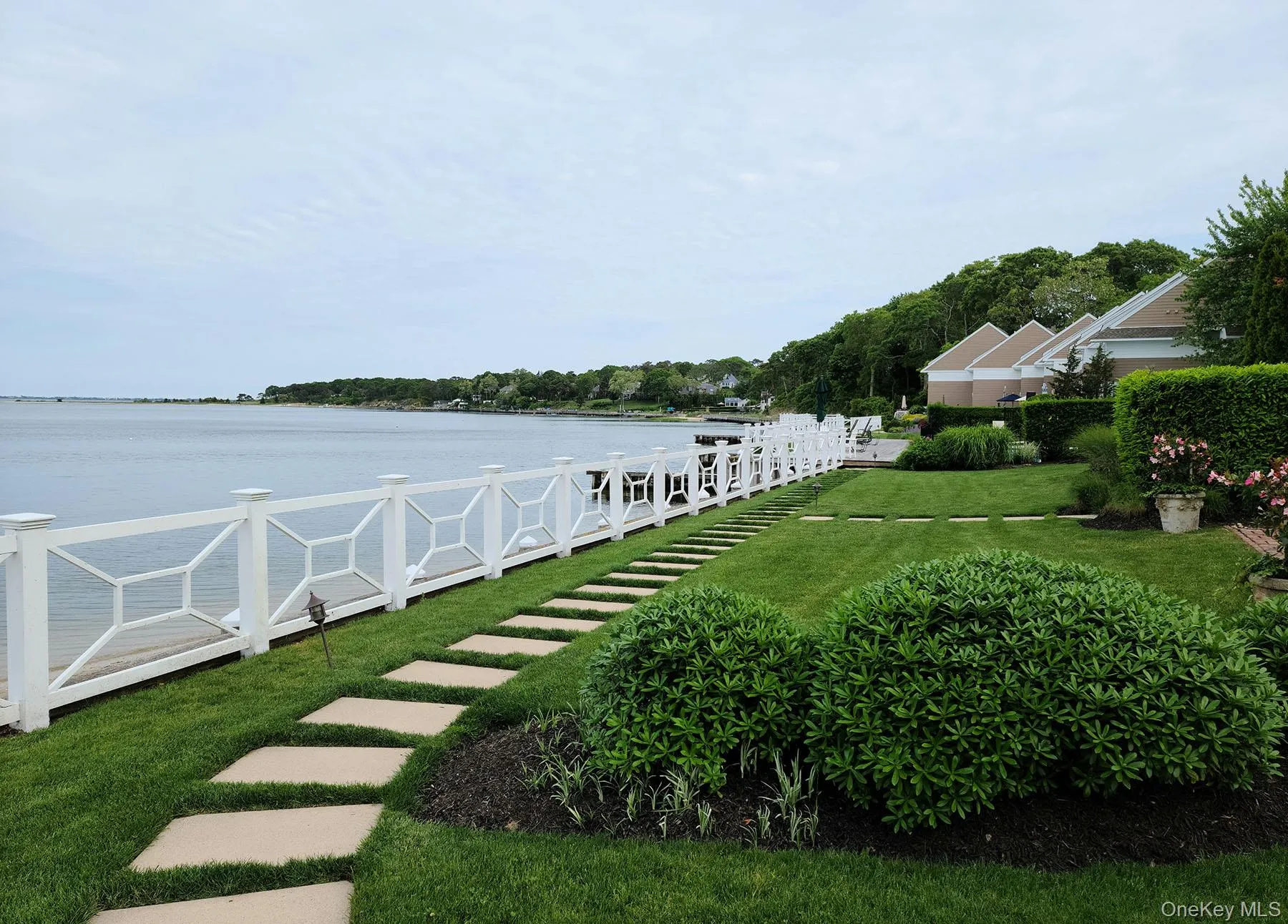 View of grassy yard featuring a water view View of grassy yard featuring a water view
