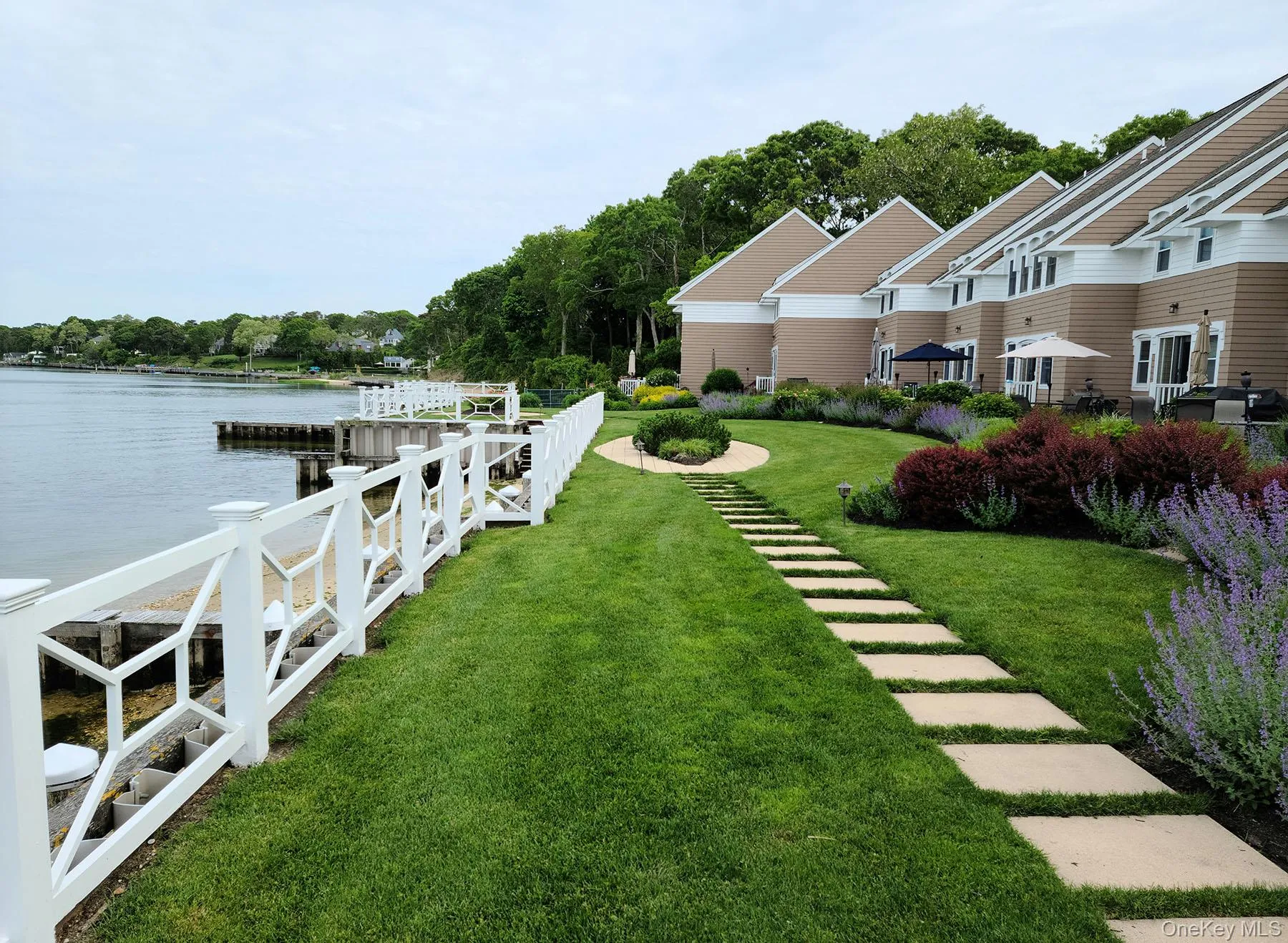 Dock area featuring a yard and a water view Dock area featuring a yard and a water view