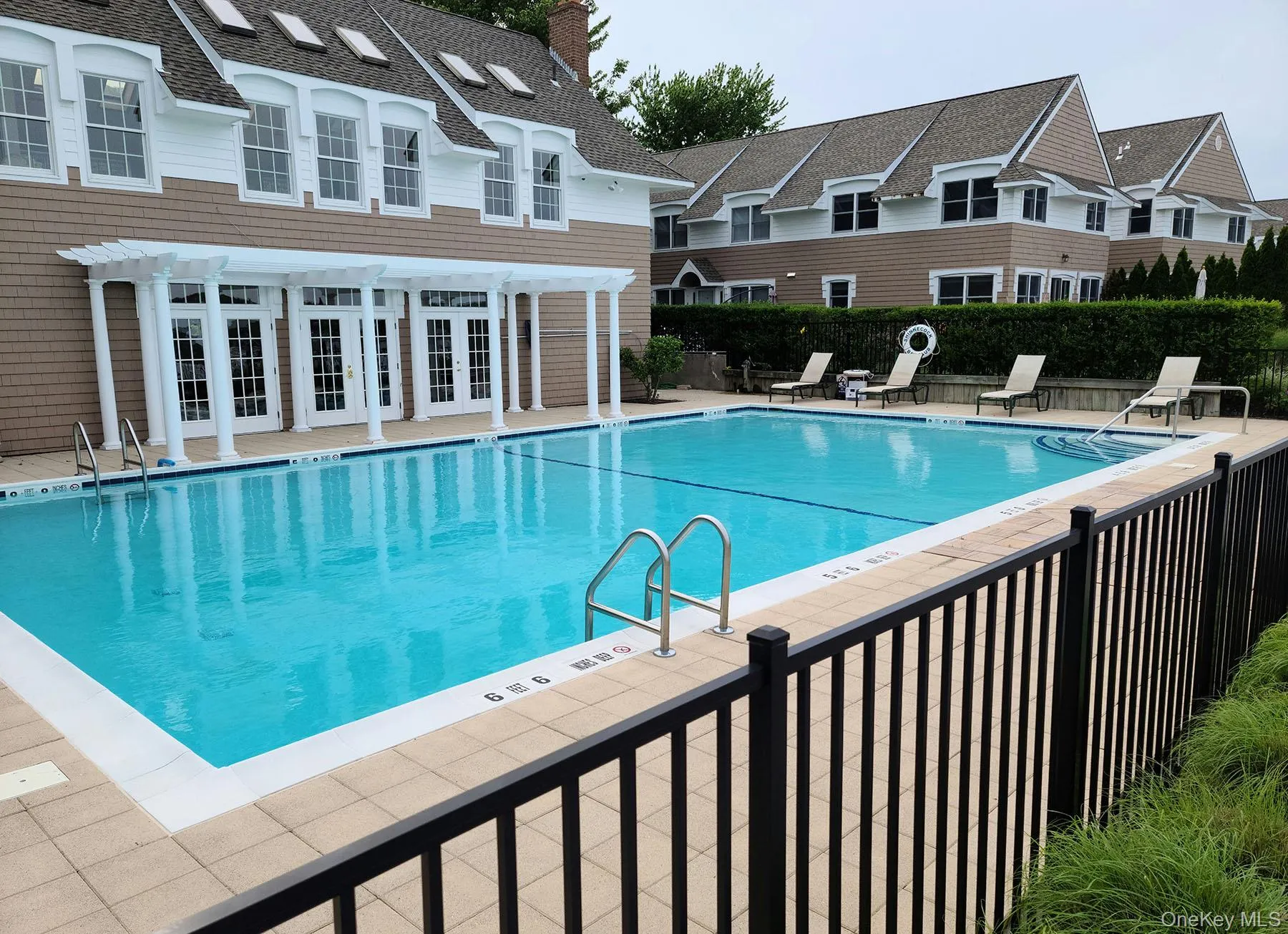 Community pool featuring a patio and french doors Community pool featuring a patio and french doors