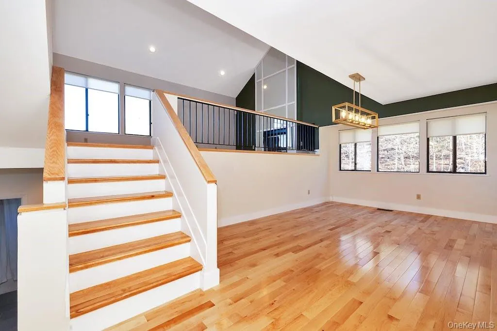 Oversized dining room. Stairs up to living room with lake view. Oversized dining room. Stairs up to living room with lake view.