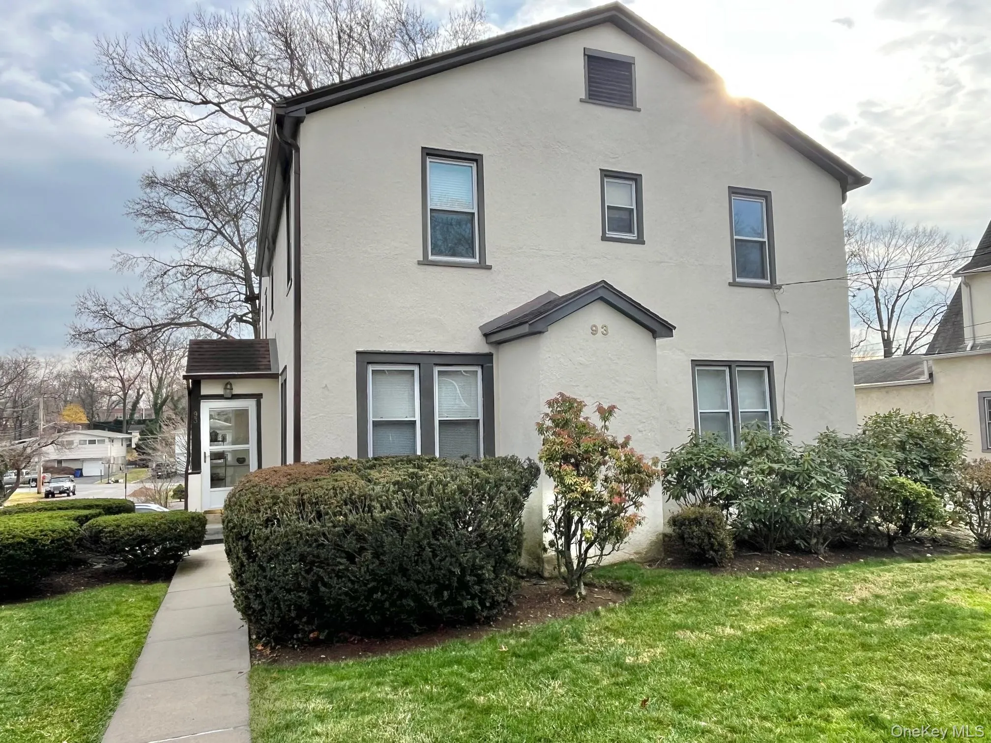 View of front of property with a front lawn and stucco siding View of front of property with a front lawn and stucco siding