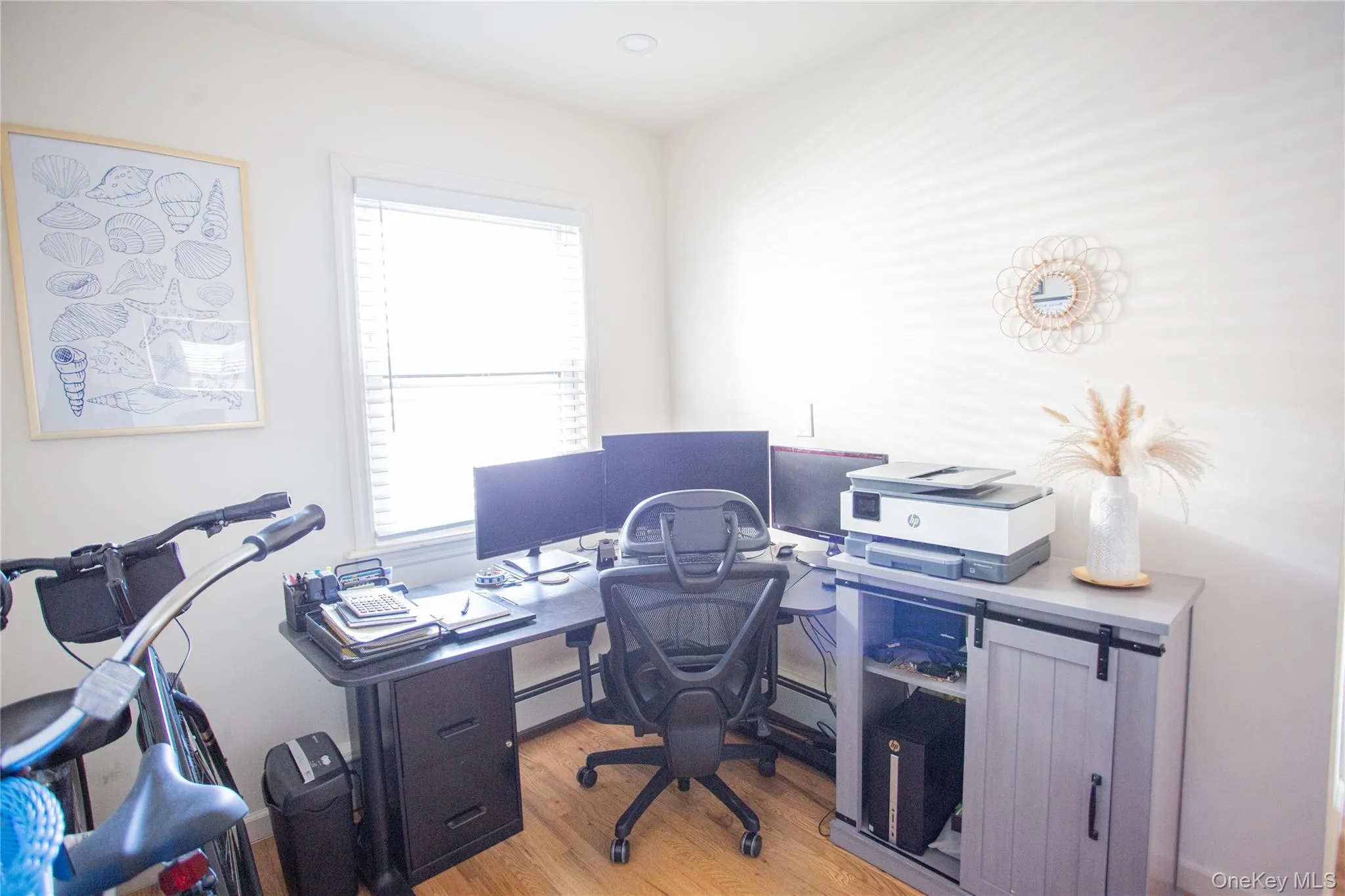 Office space with light wood-style flooring and baseboard heating Office space with light wood-style flooring and baseboard heating