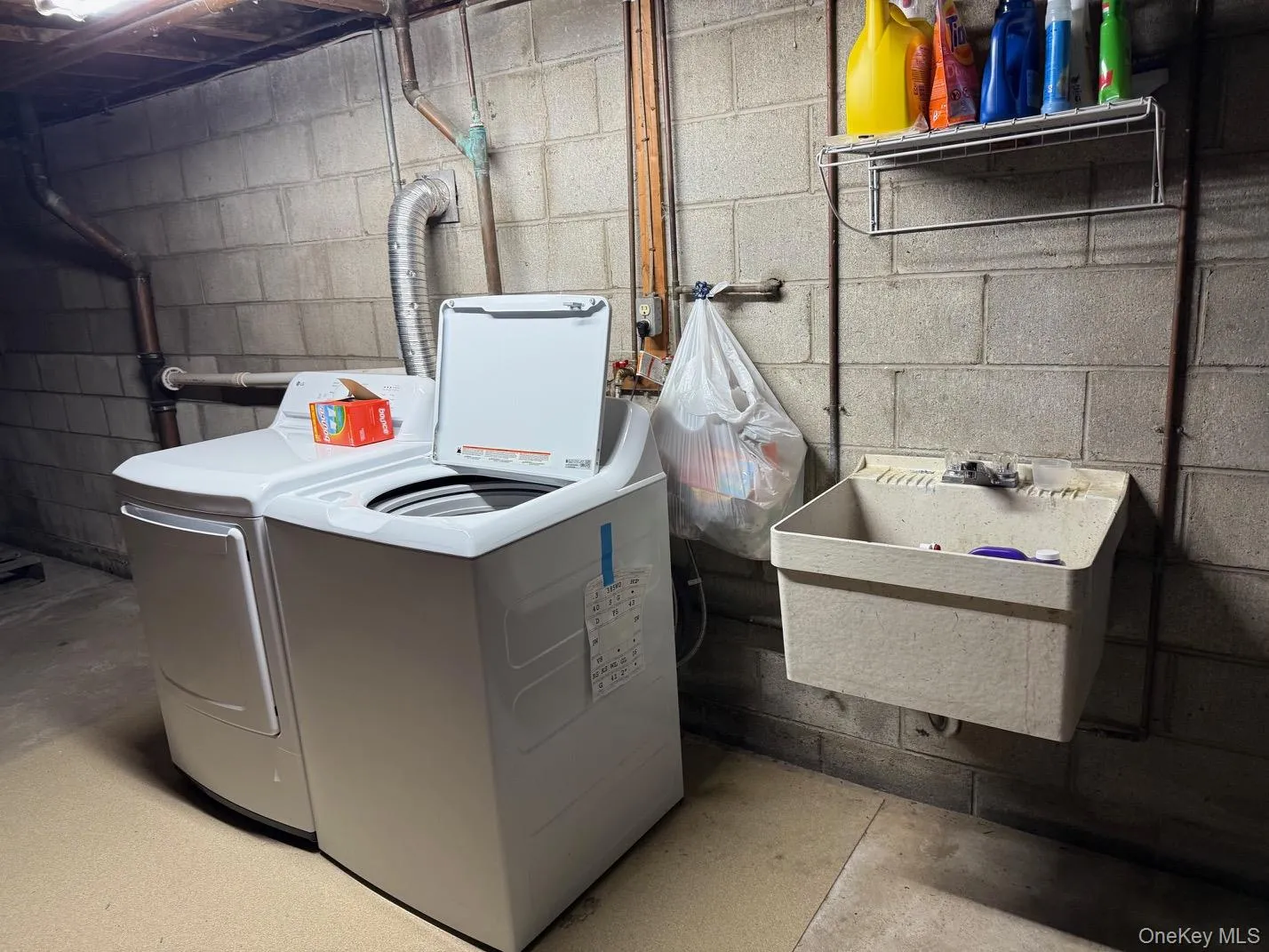 Laundry in basement with walkout door to driveway Laundry in basement with walkout door to driveway