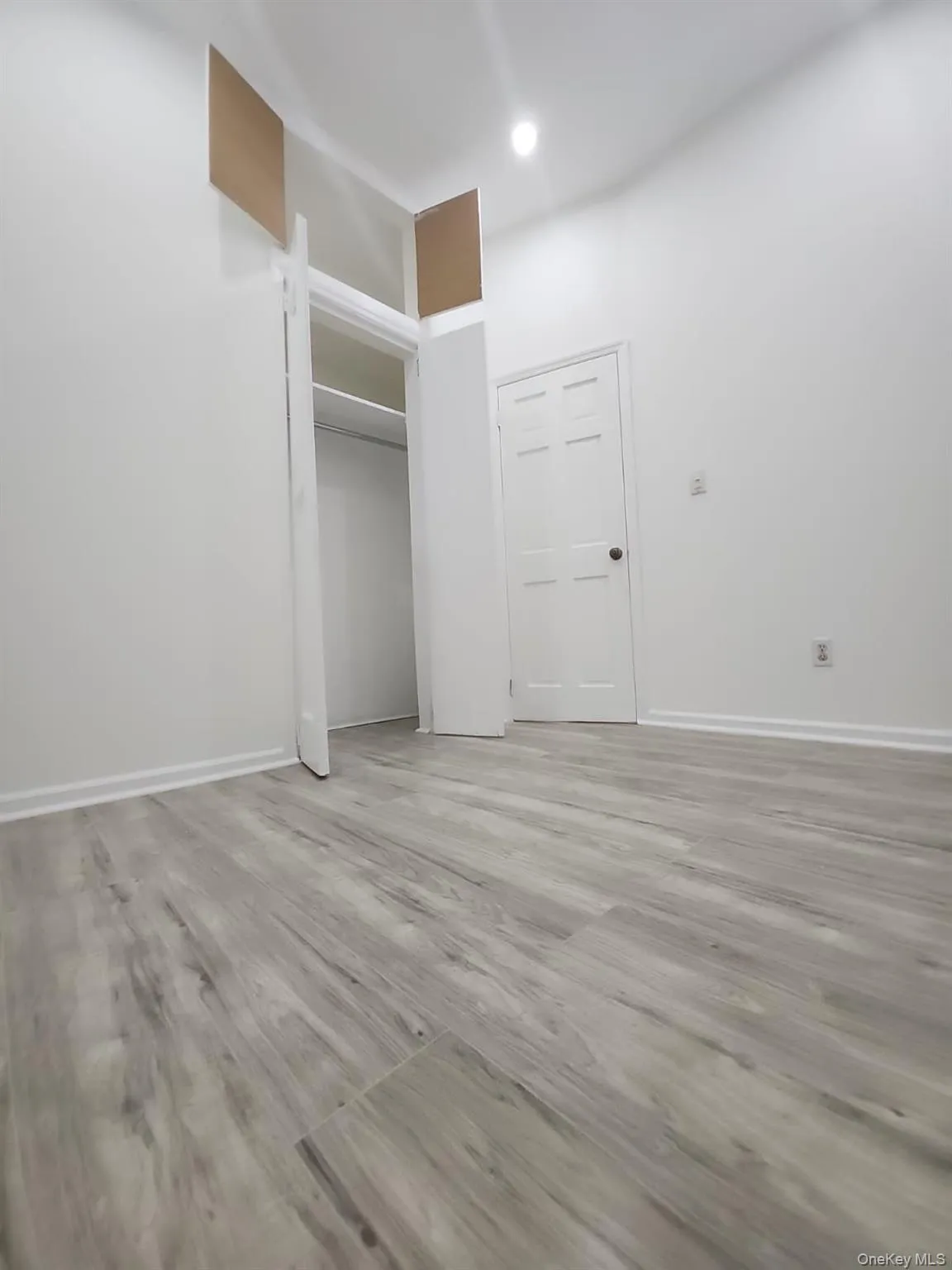 Unfurnished bedroom featuring light wood finished floors and a closet Unfurnished bedroom featuring light wood finished floors and a closet