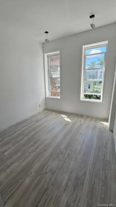 Empty room featuring wood finished floors Empty room featuring wood finished floors