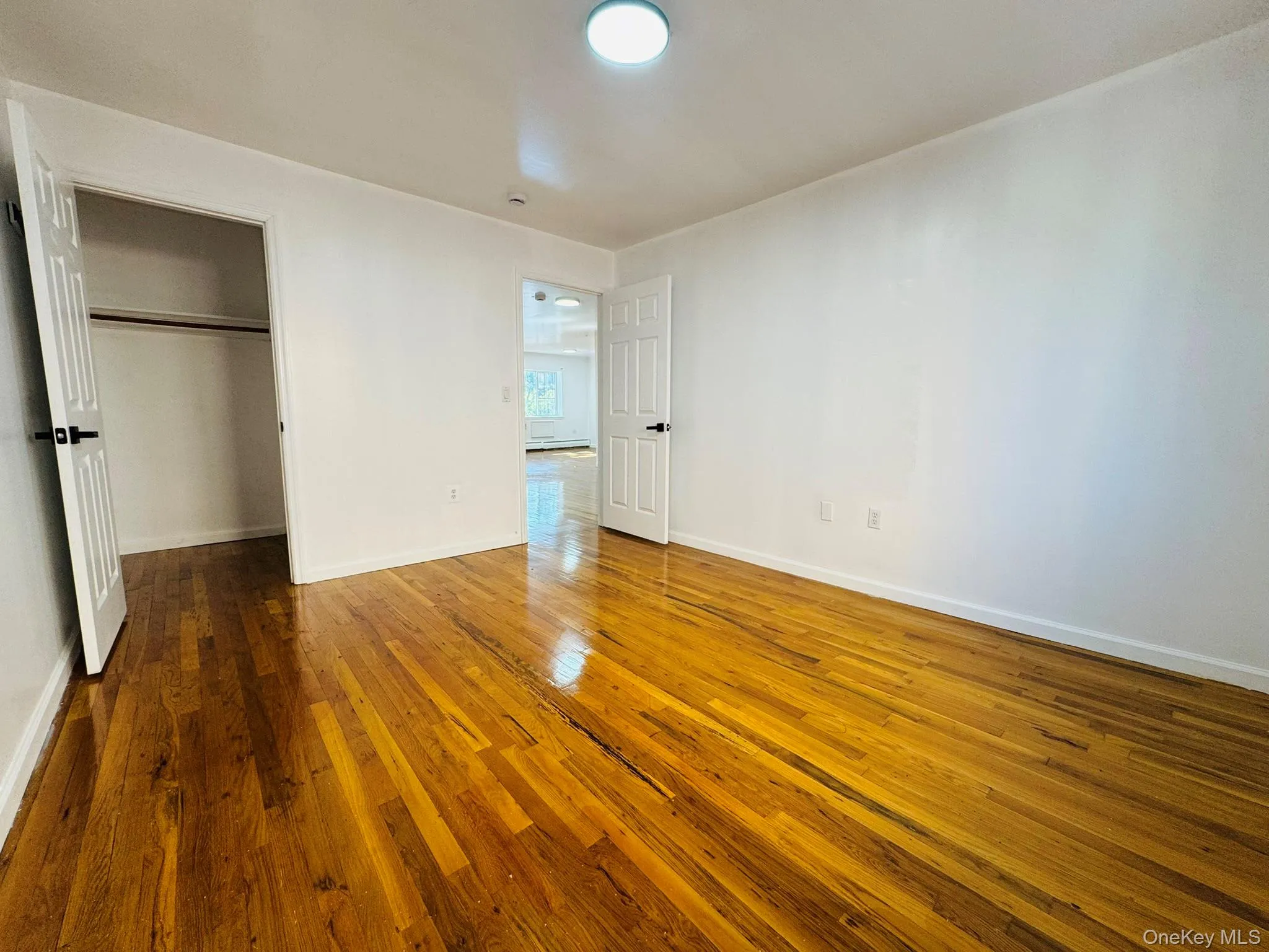 Unfurnished bedroom featuring hardwood / wood-style floors and a closet Unfurnished bedroom featuring hardwood / wood-style floors and a closet
