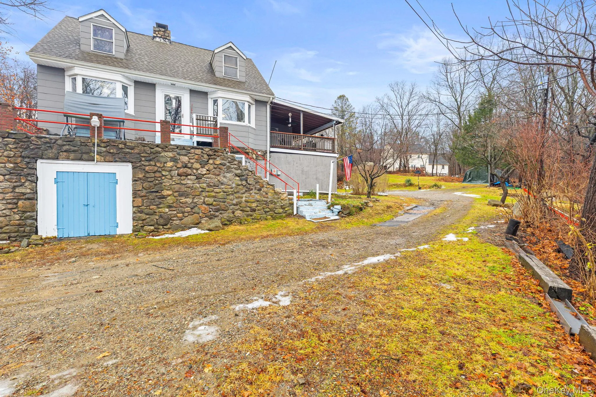 View of front of property with stairs, a chimney, and a shingled roof View of front of property with stairs, a chimney, and a shingled roof