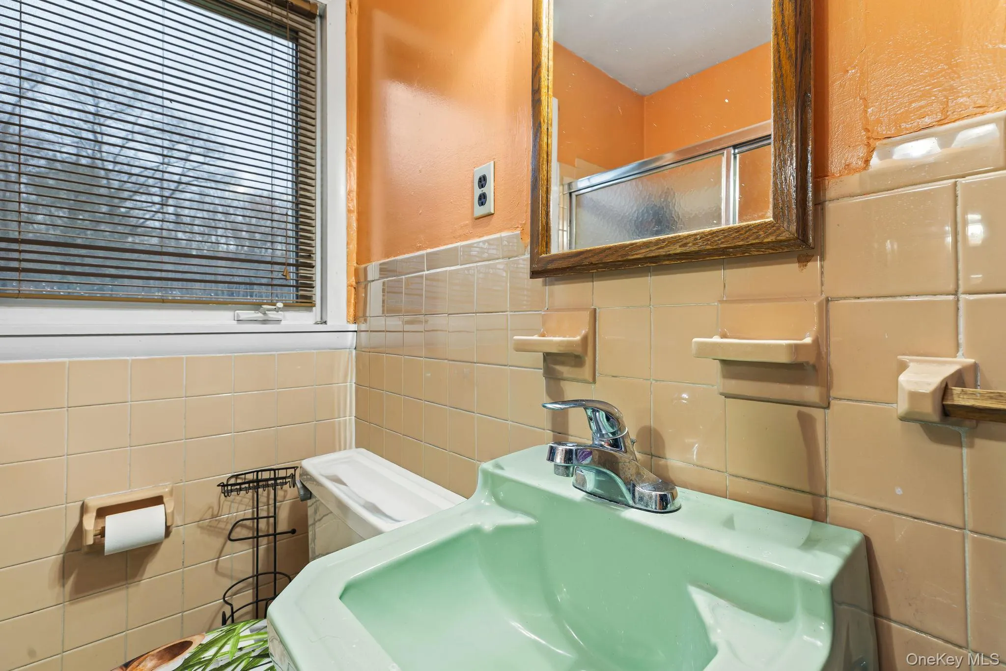 Bathroom with a shower with door and tile walls Bathroom with a shower with door and tile walls