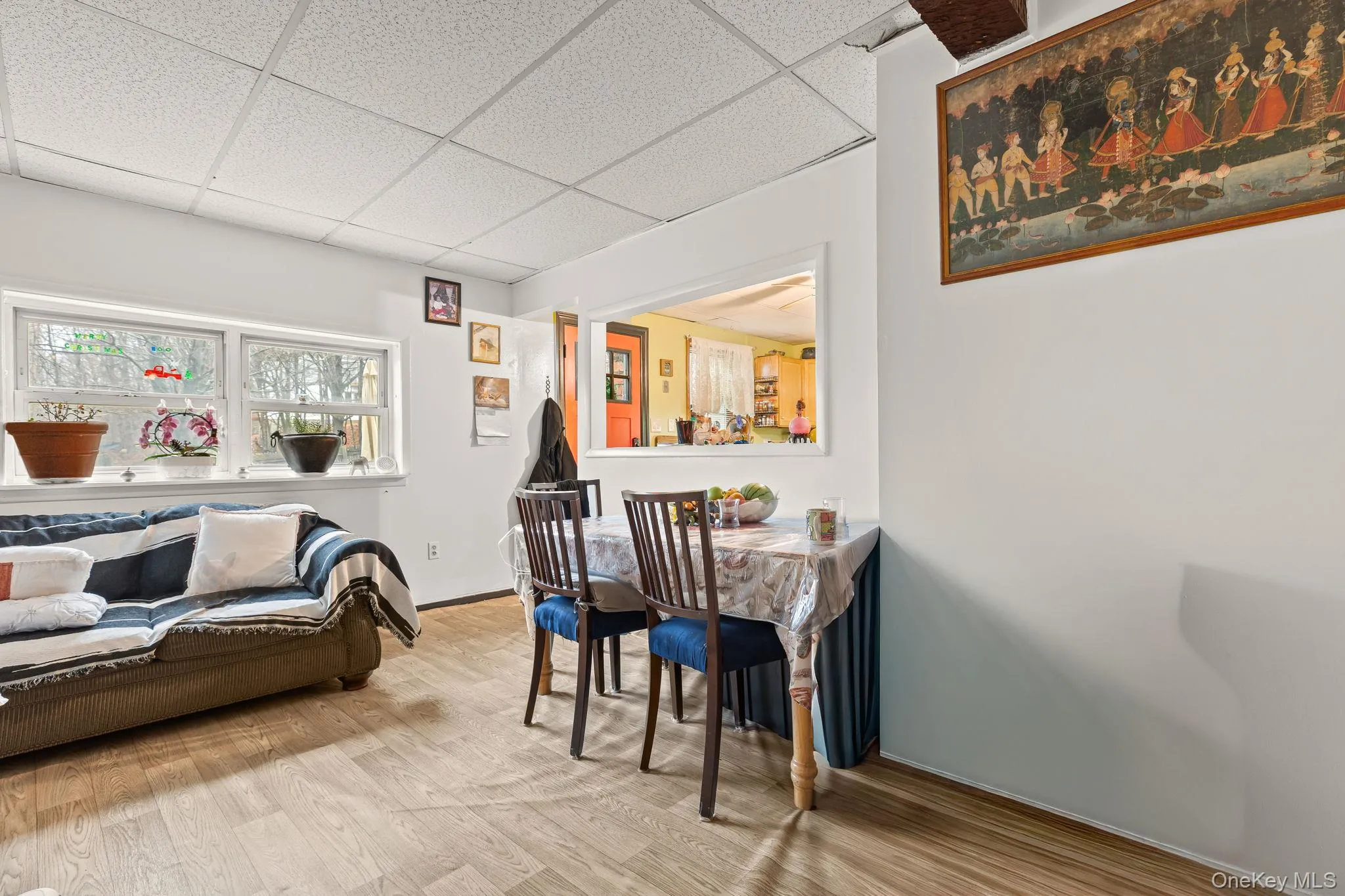Dining space with a drop ceiling and wood finished floors Dining space with a drop ceiling and wood finished floors
