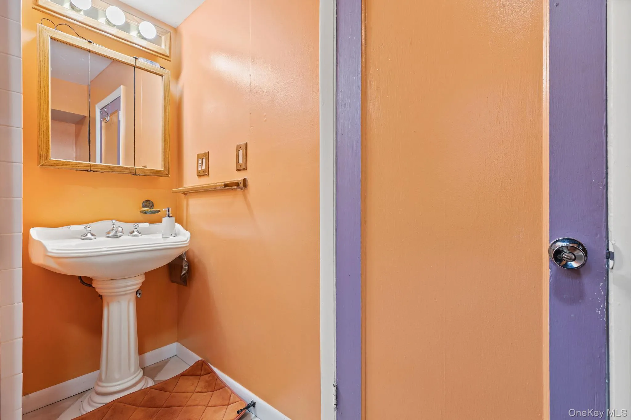 Bathroom featuring tile patterned flooring and baseboards Bathroom featuring tile patterned flooring and baseboards