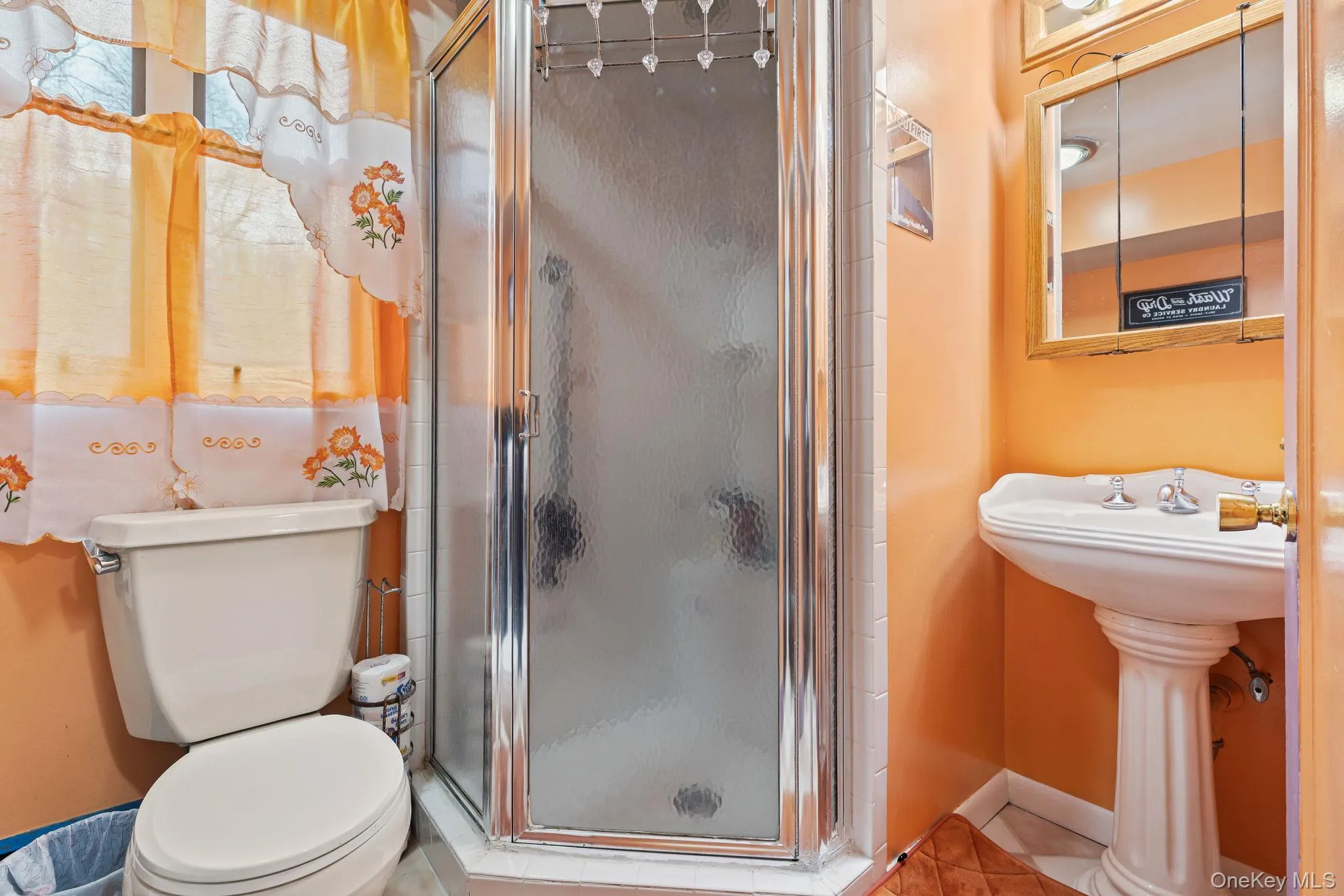 Full bath with a stall shower and tile patterned flooring Full bath with a stall shower and tile patterned flooring