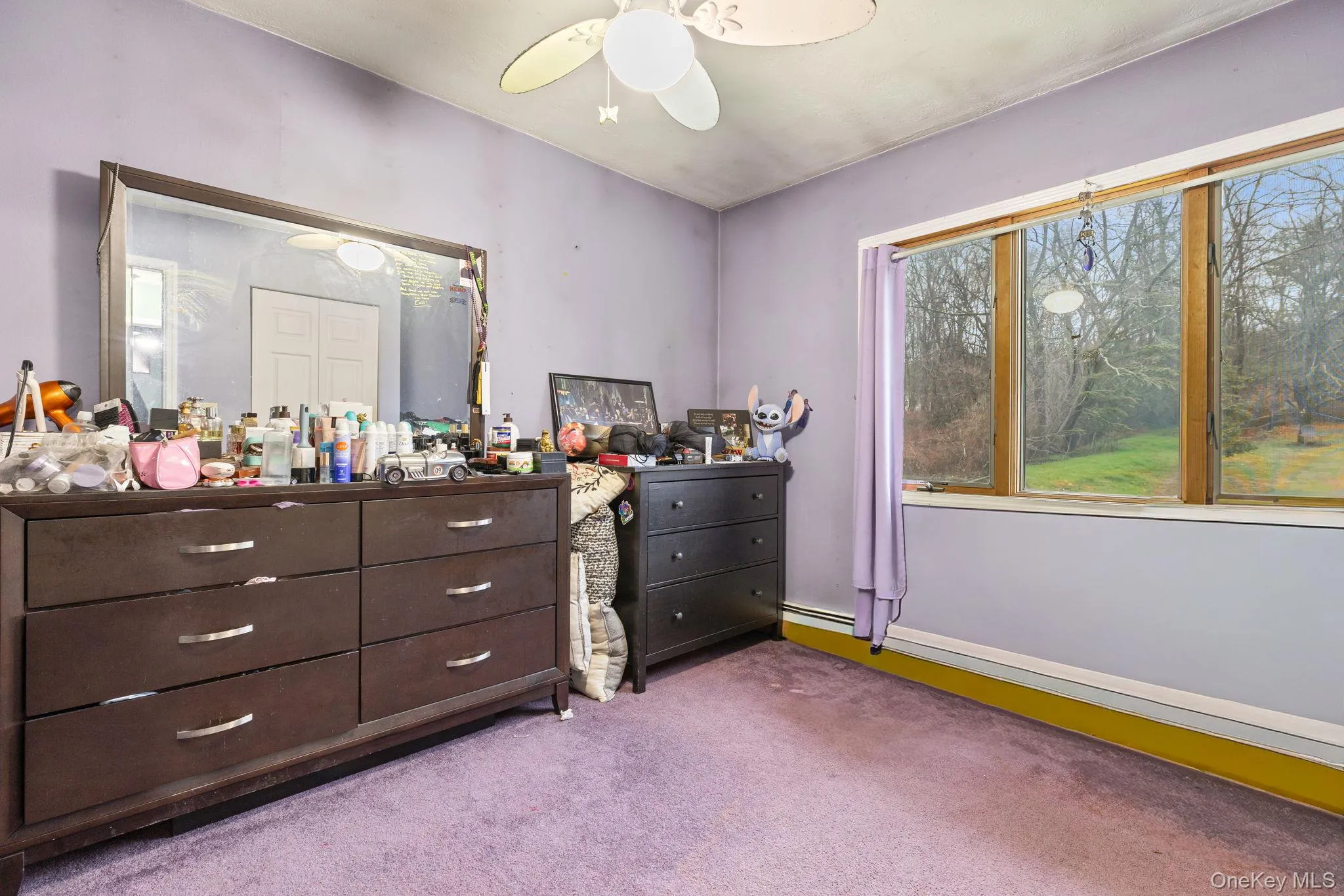 Bedroom featuring light carpet and a ceiling fan Bedroom featuring light carpet and a ceiling fan