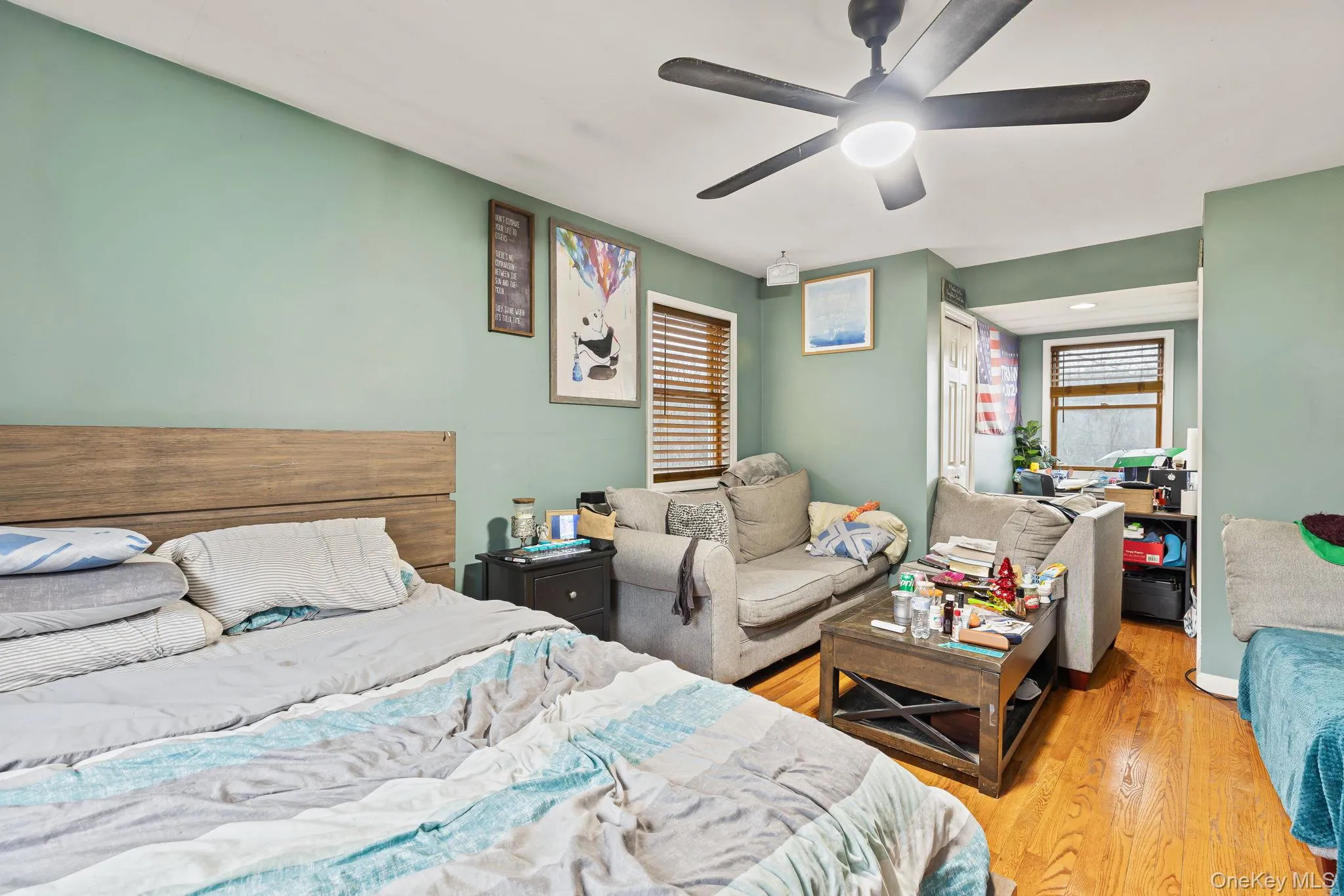 Bedroom with a closet, wood finished floors, and a ceiling fan Bedroom with a closet, wood finished floors, and a ceiling fan