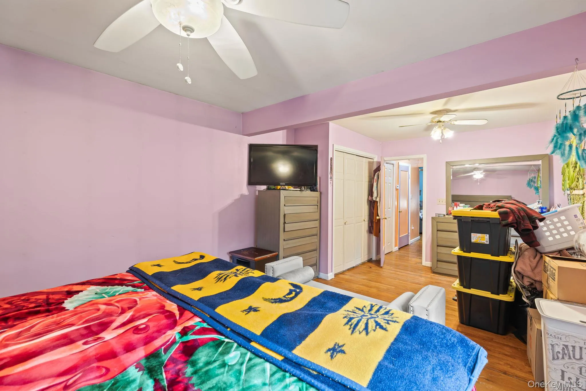 Bedroom featuring light wood-style floors, a closet, and ceiling fan Bedroom featuring light wood-style floors, a closet, and ceiling fan