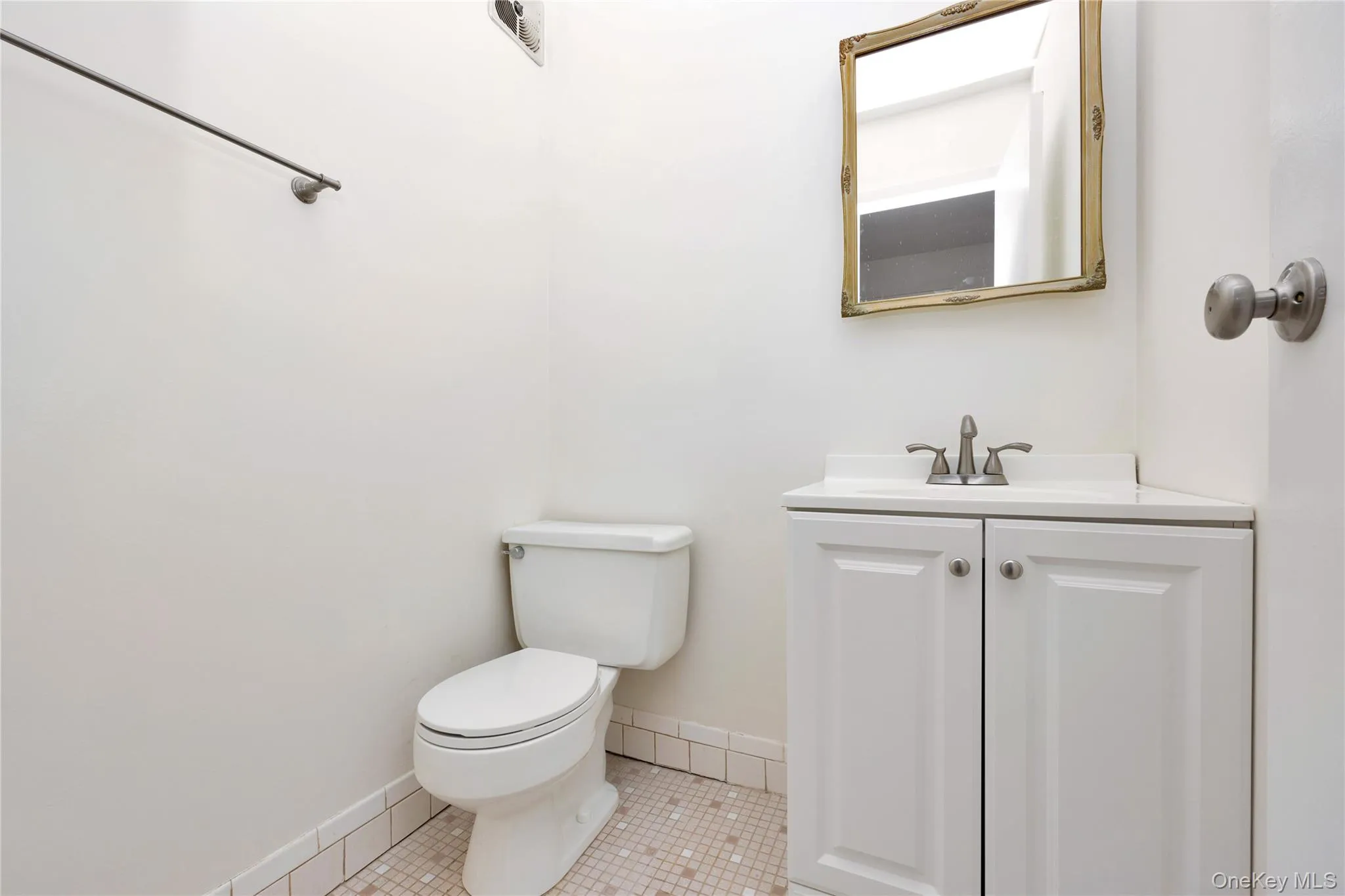 Bathroom featuring light tile patterned floors and vanity Bathroom featuring light tile patterned floors and vanity