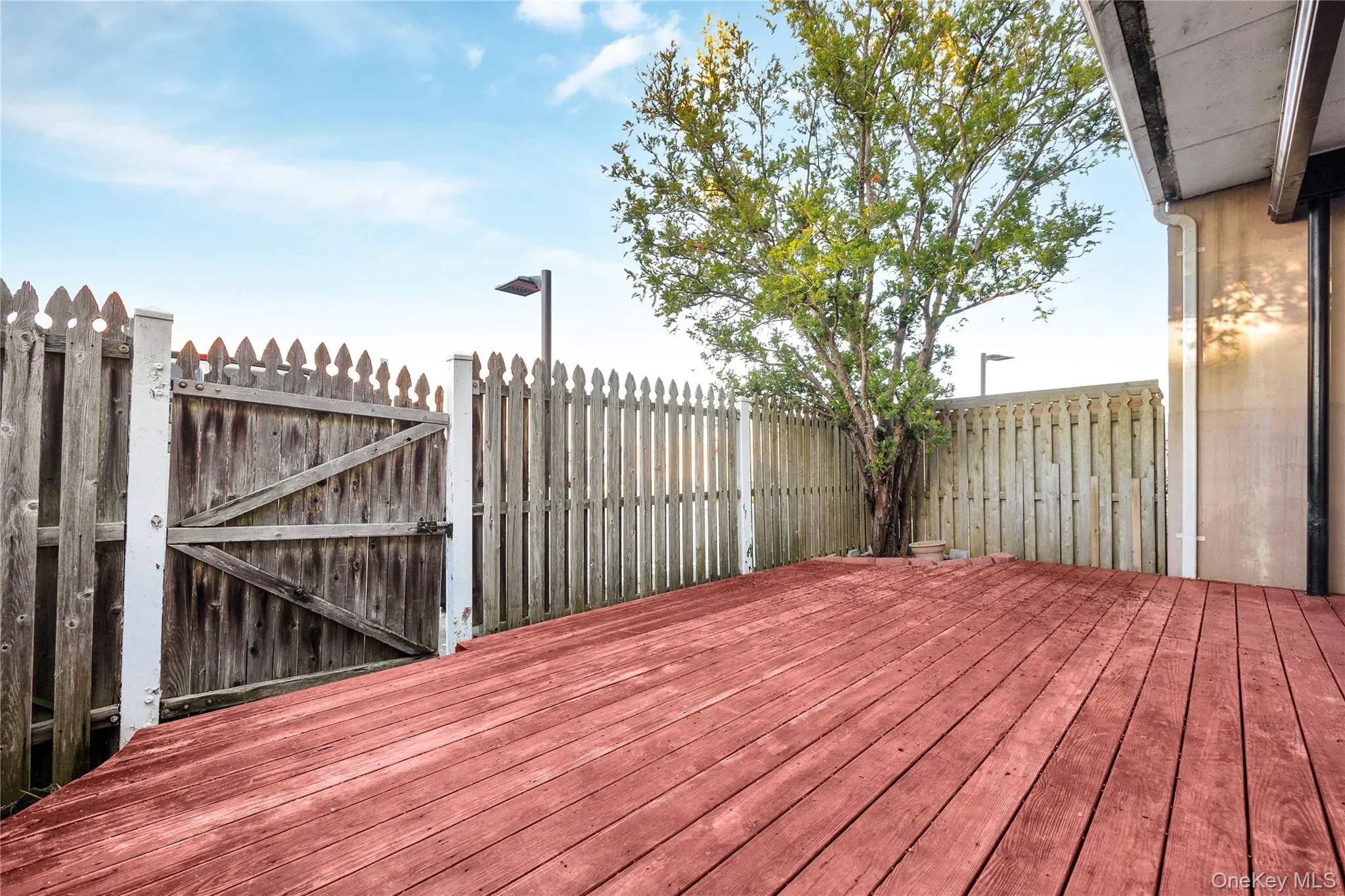 Wooden terrace with a fenced backyard Wooden terrace with a fenced backyard