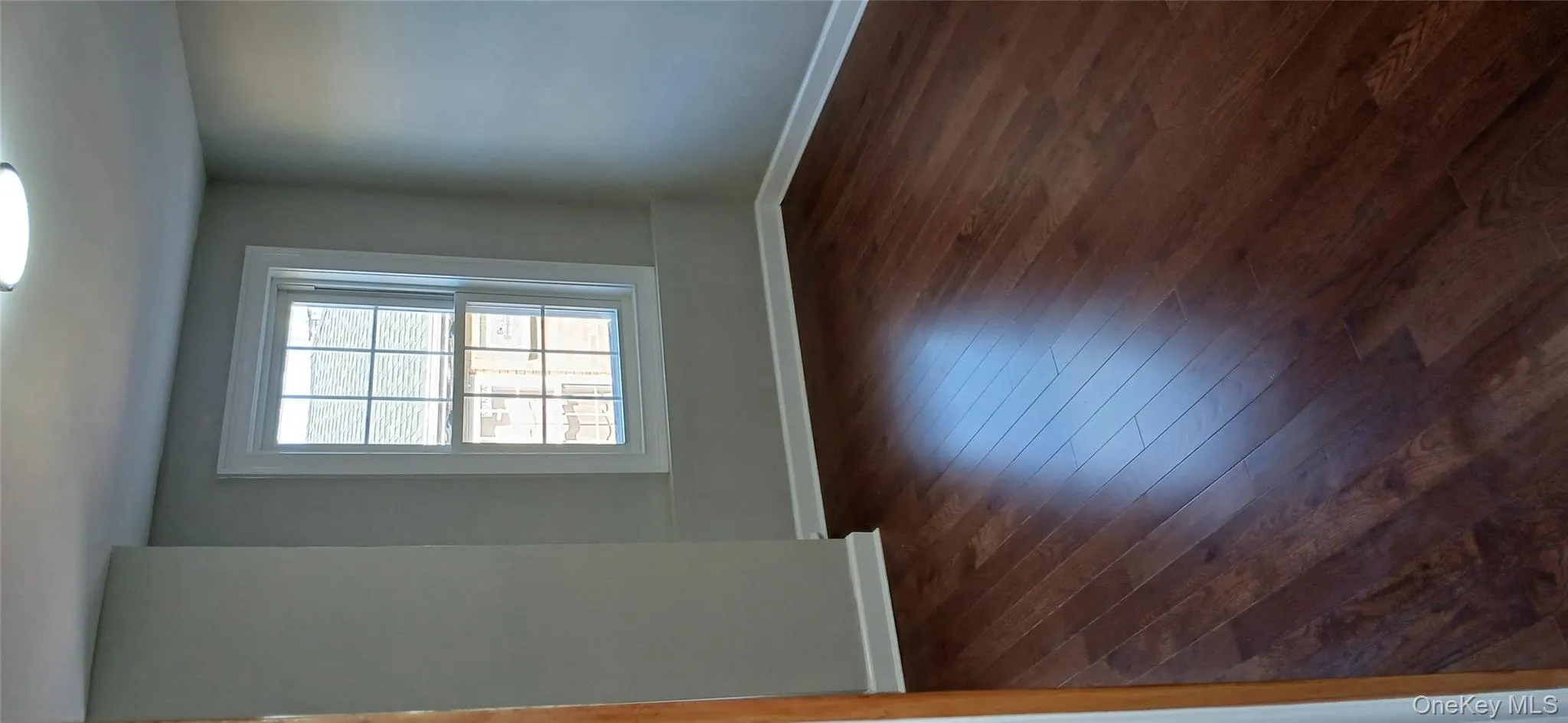 Unfurnished room featuring baseboards and dark wood-style flooring Unfurnished room featuring baseboards and dark wood-style flooring