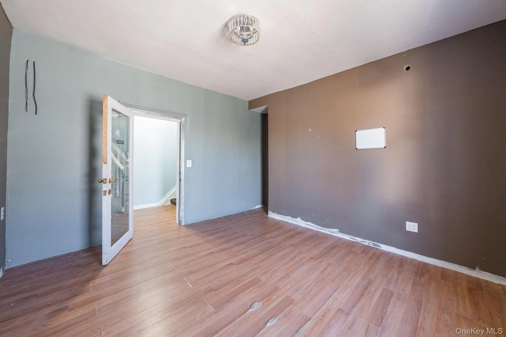 Empty room with light wood-style flooring and baseboards Empty room with light wood-style flooring and baseboards