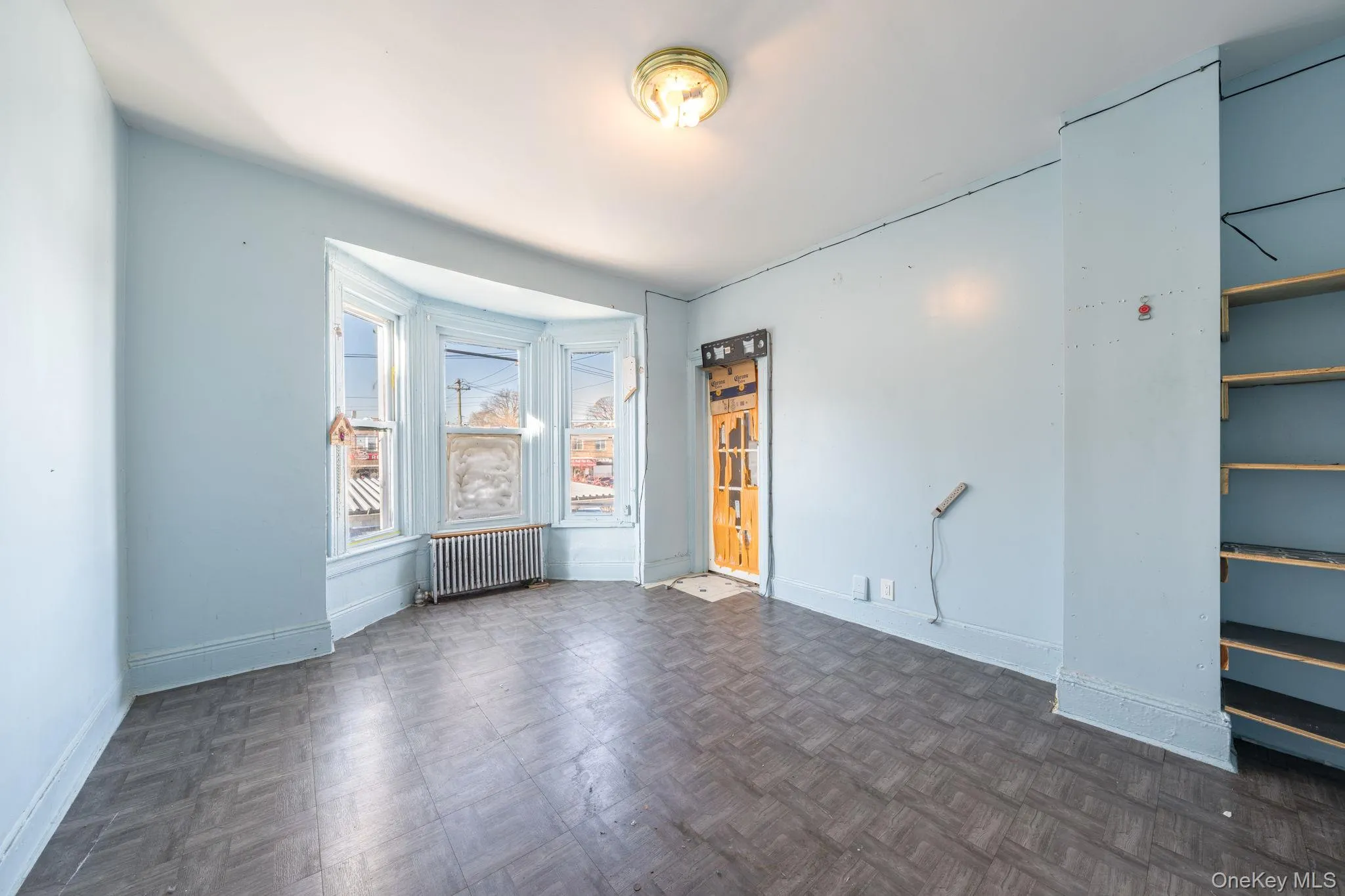 Spare room featuring radiator heating unit and baseboards Spare room featuring radiator heating unit and baseboards