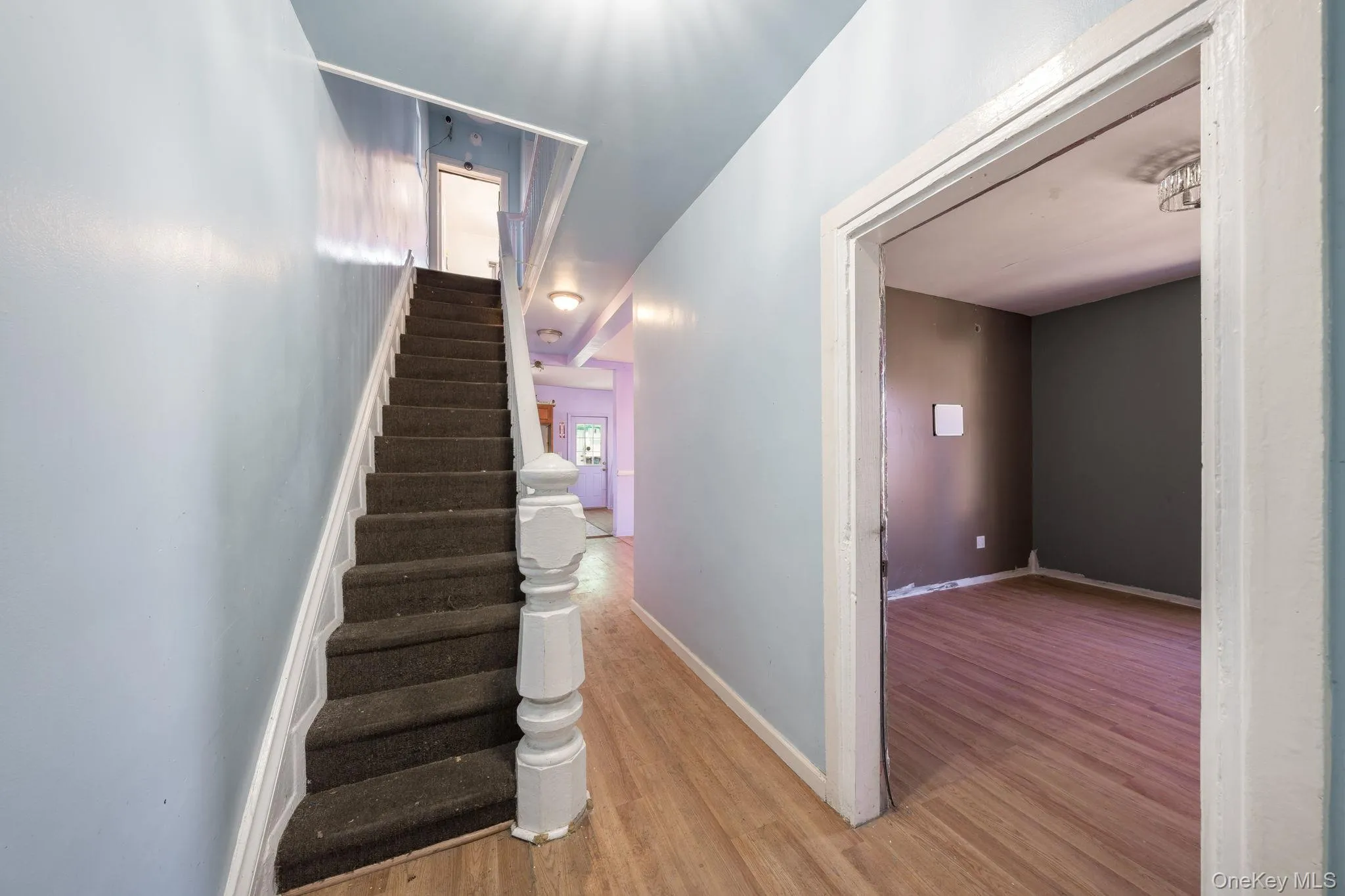 Stairs with baseboards and wood finished floors Stairs with baseboards and wood finished floors