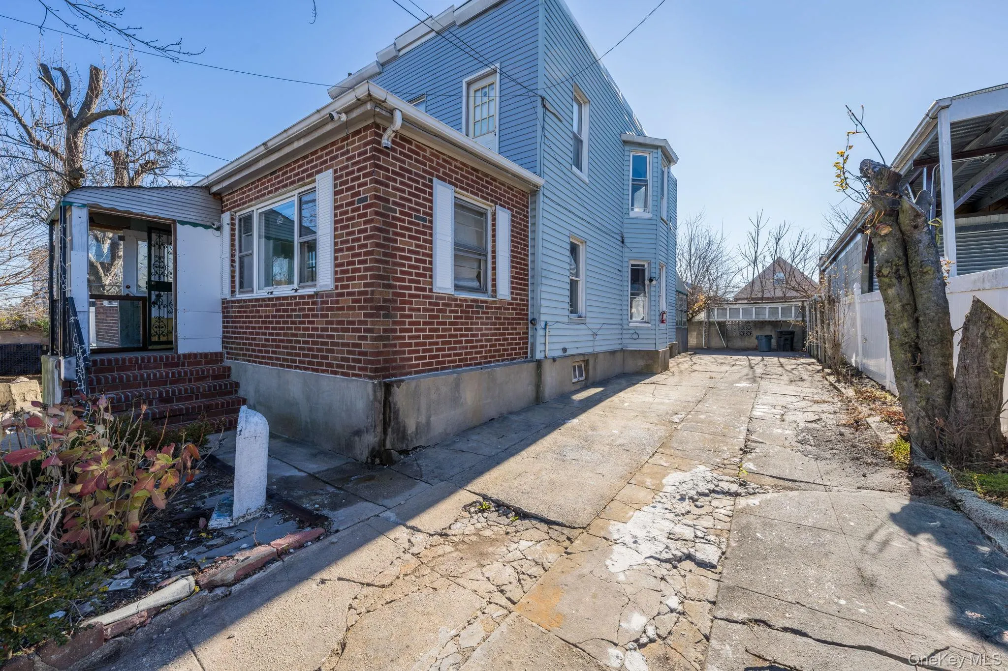 View of side of home with brick siding and driveway View of side of home with brick siding and driveway