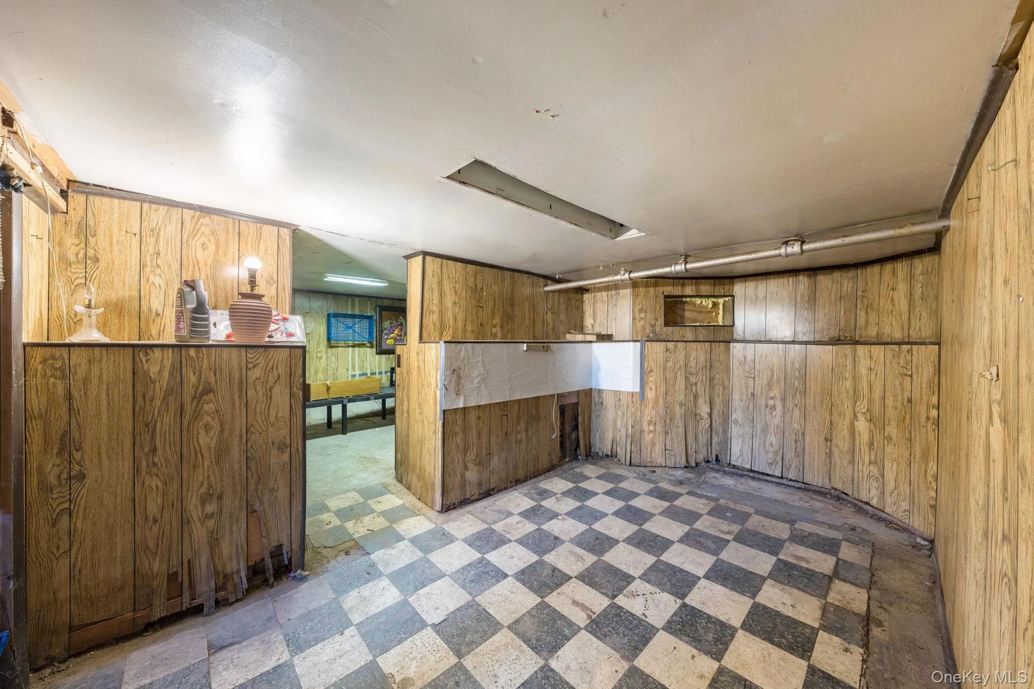Finished basement with light floors and wood walls Finished basement with light floors and wood walls