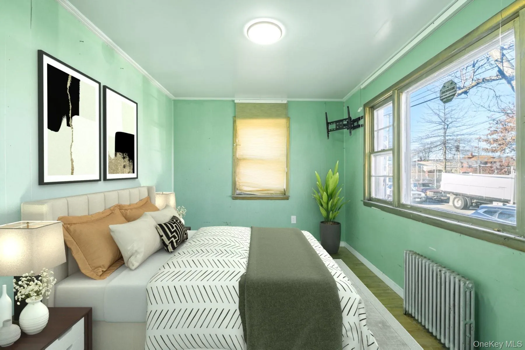 Bedroom with radiator, wood finished floors, and ornamental molding Bedroom with radiator, wood finished floors, and ornamental molding