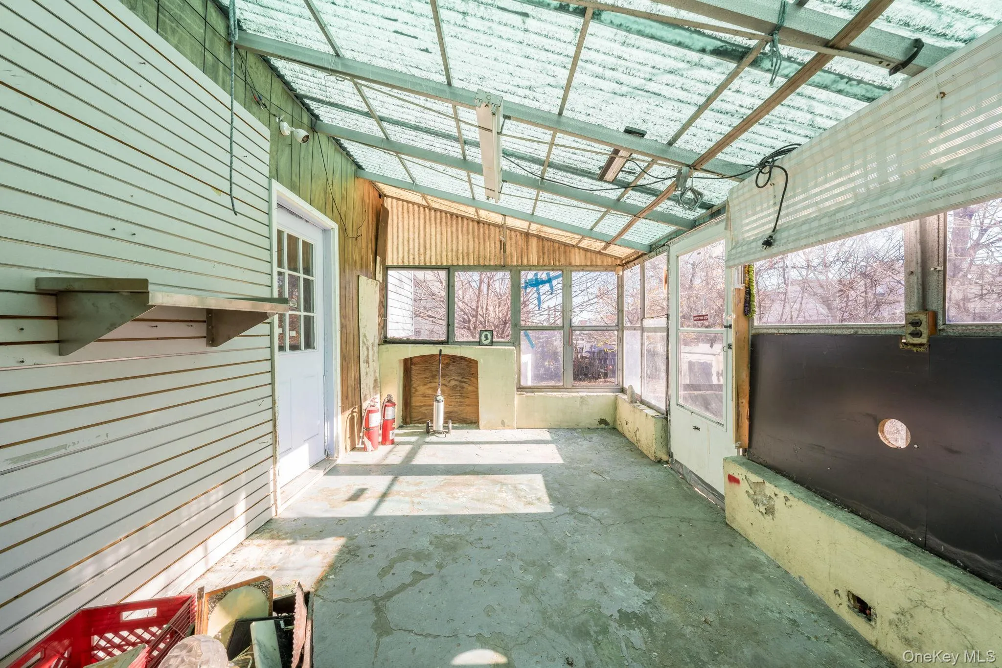 Unfurnished sunroom featuring vaulted ceiling and a patio area Unfurnished sunroom featuring vaulted ceiling and a patio area