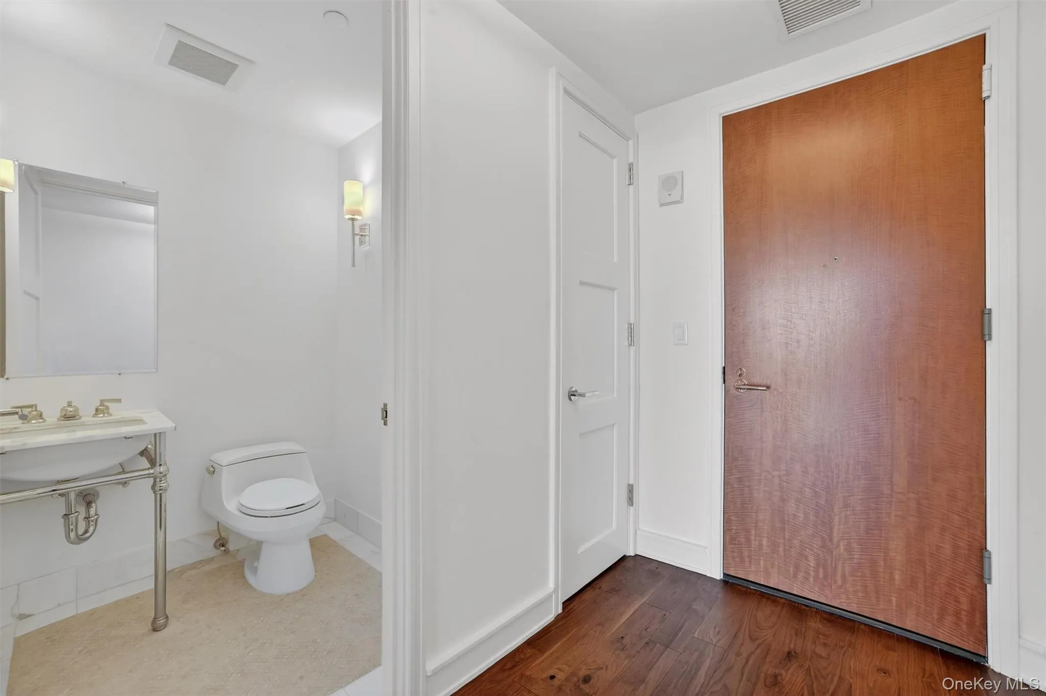 Half bathroom with baseboards and dark wood finished floors Half bathroom with baseboards and dark wood finished floors