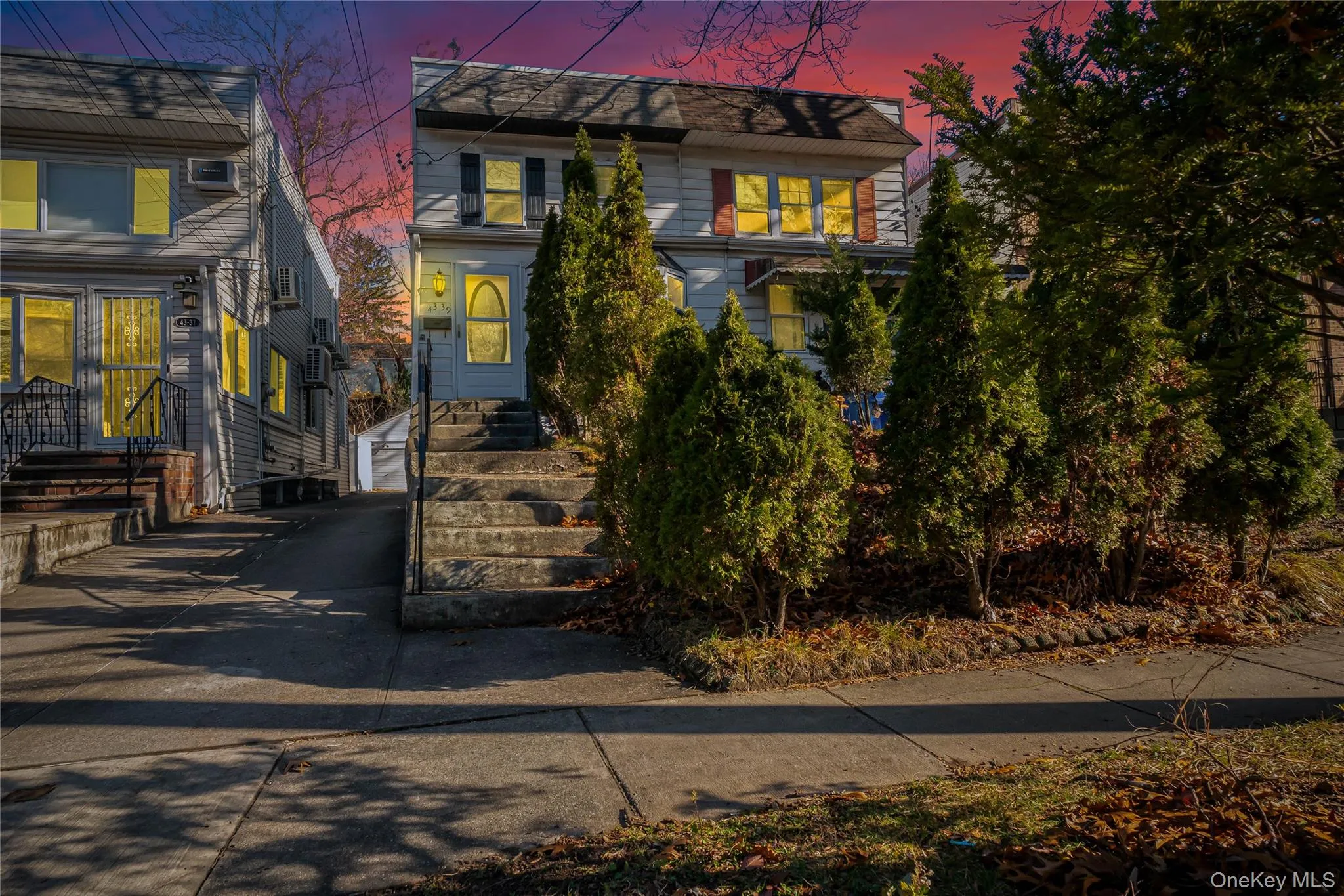View of front of house with a wall mounted air conditioner and driveway View of front of house with a wall mounted air conditioner and driveway