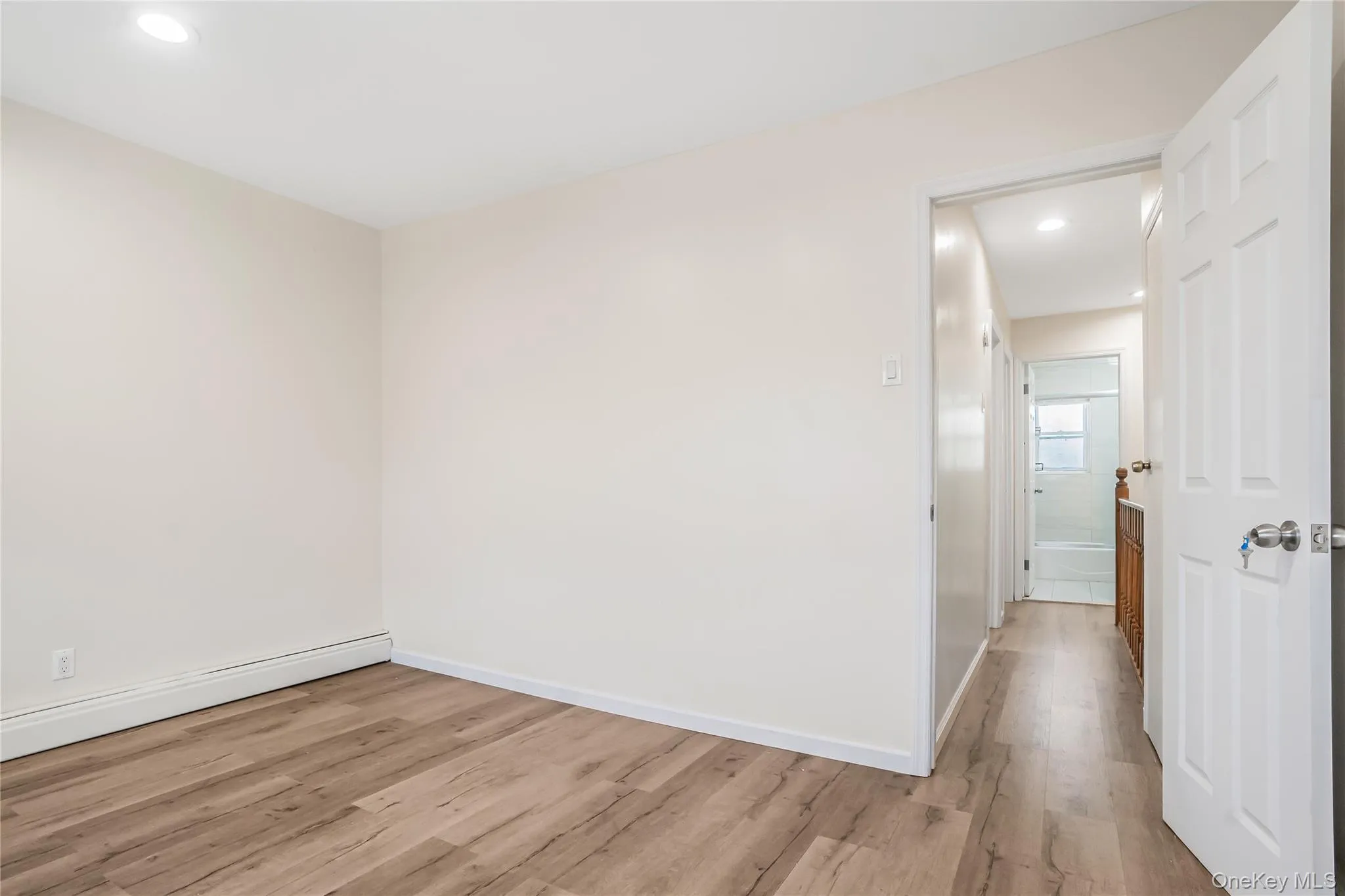 Empty room with recessed lighting and wood finished floors Empty room with recessed lighting and wood finished floors