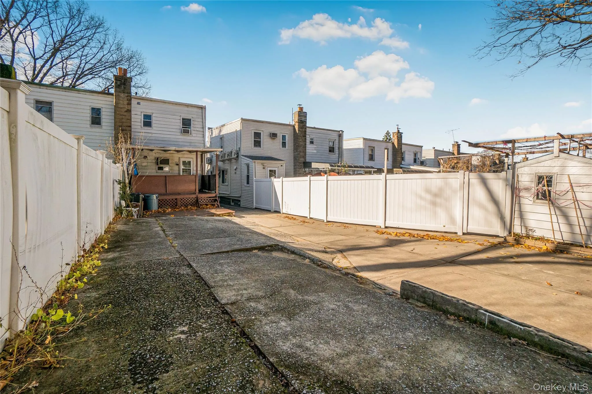 Fenced backyard with a deck and a residential view Fenced backyard with a deck and a residential view