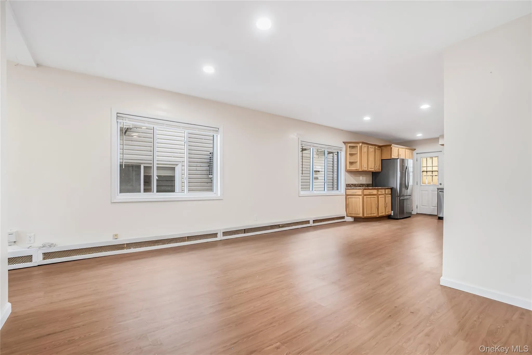 Unfurnished living room featuring light wood-style floors and recessed lighting Unfurnished living room featuring light wood-style floors and recessed lighting