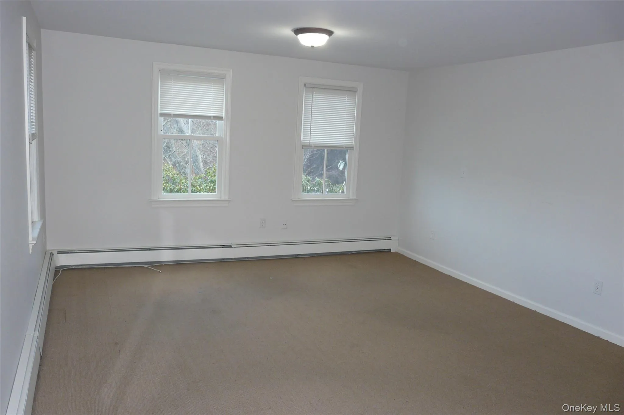 Carpeted office with north and west exposures. Carpeted office with north and west exposures.