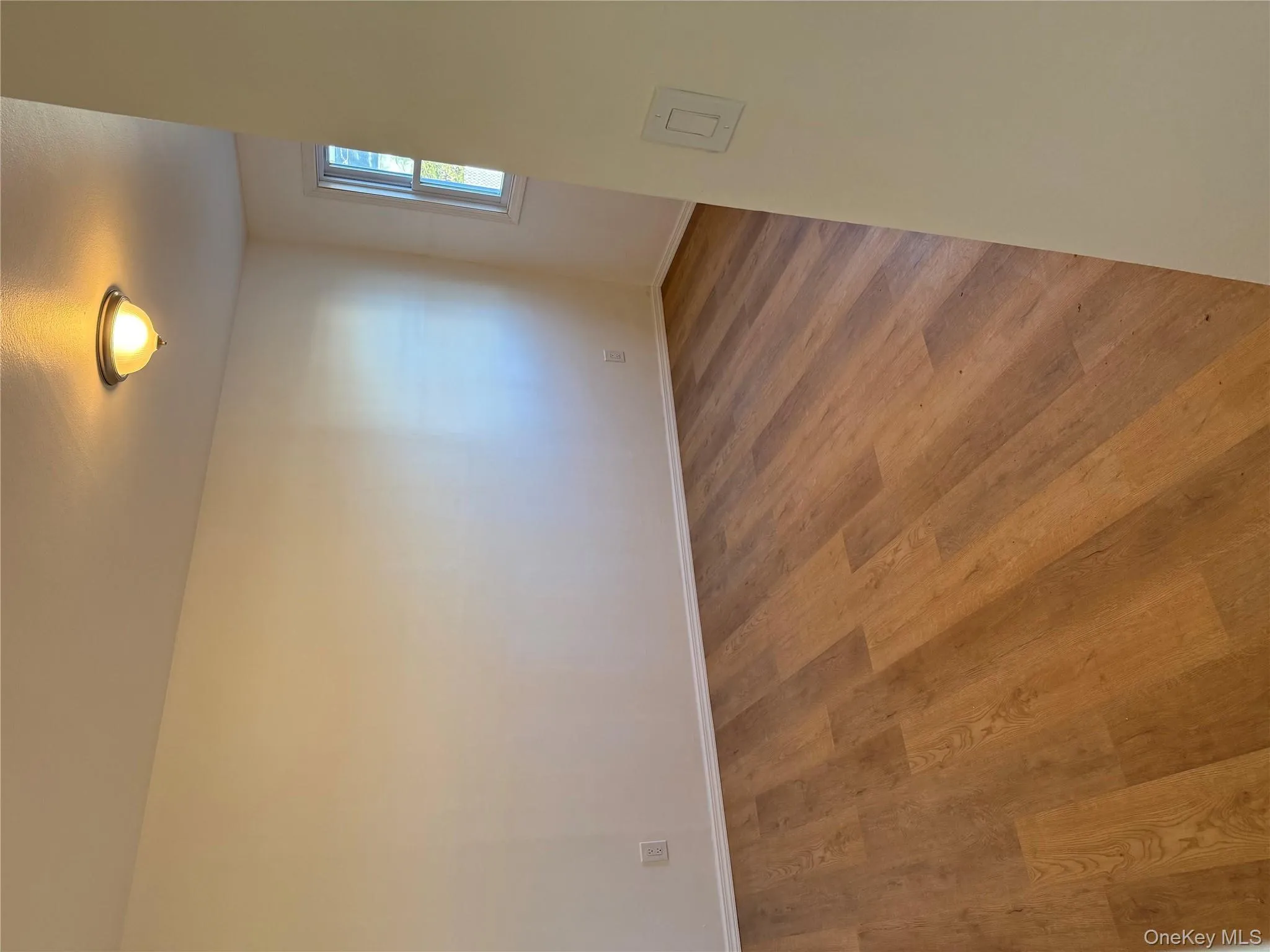 Unfurnished room with wood finished floors and baseboards Unfurnished room with wood finished floors and baseboards