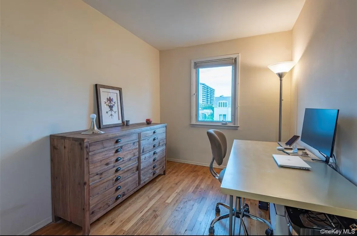 Home office with light wood finished floors and baseboards Home office with light wood finished floors and baseboards