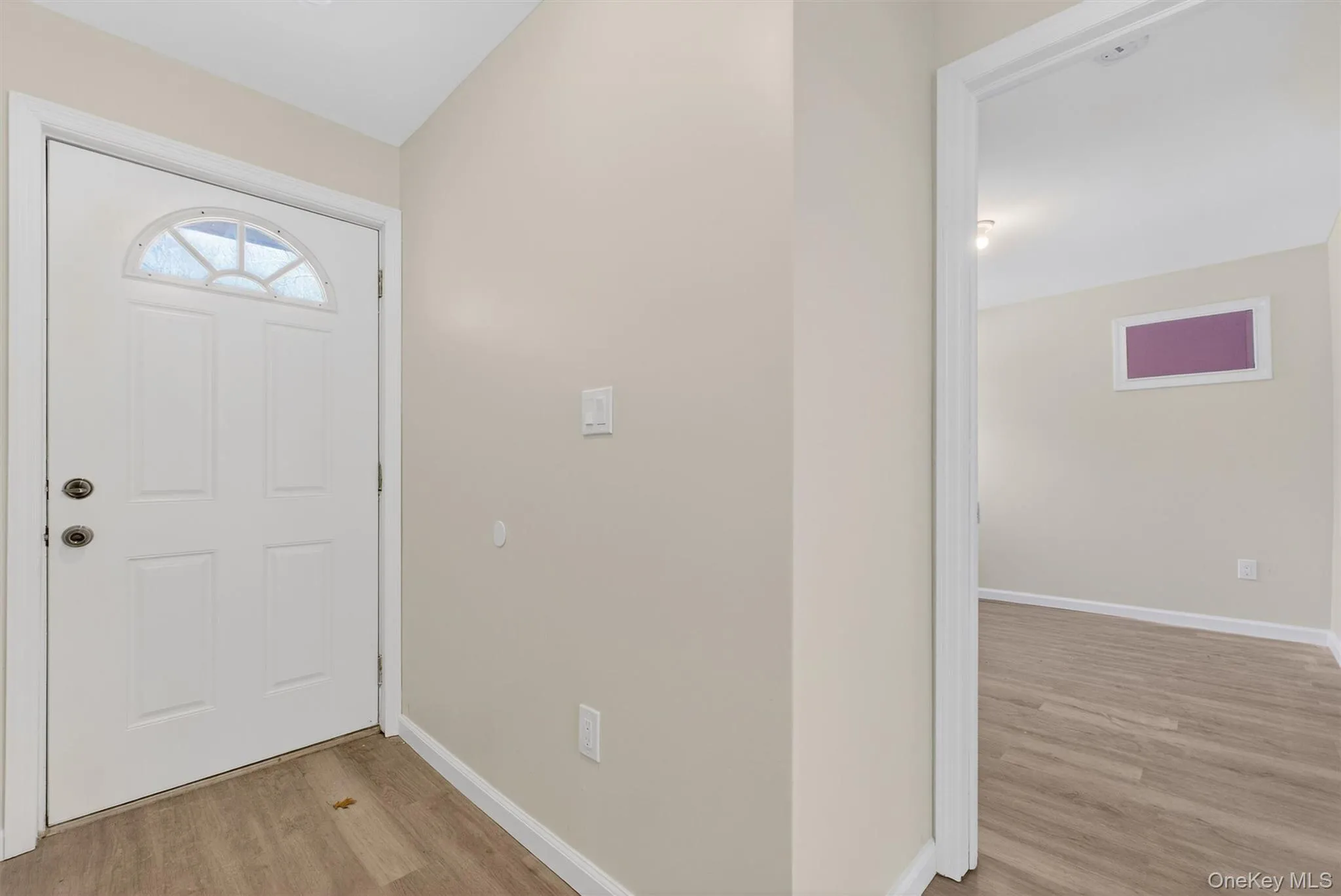 Entryway featuring light wood-style floors and baseboards Entryway featuring light wood-style floors and baseboards