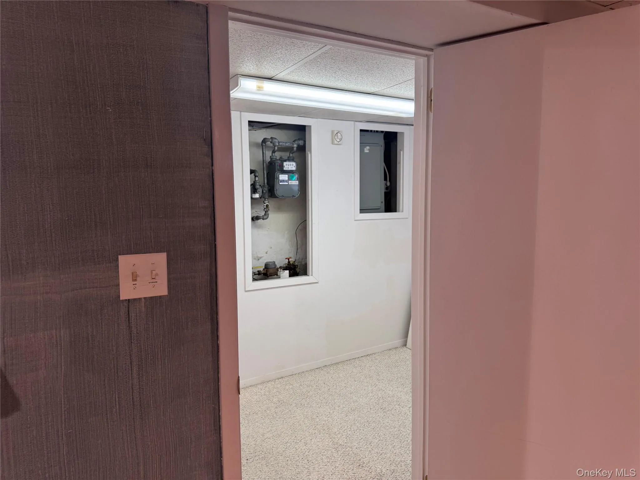 Hallway with a drop ceiling and carpet floors Hallway with a drop ceiling and carpet floors