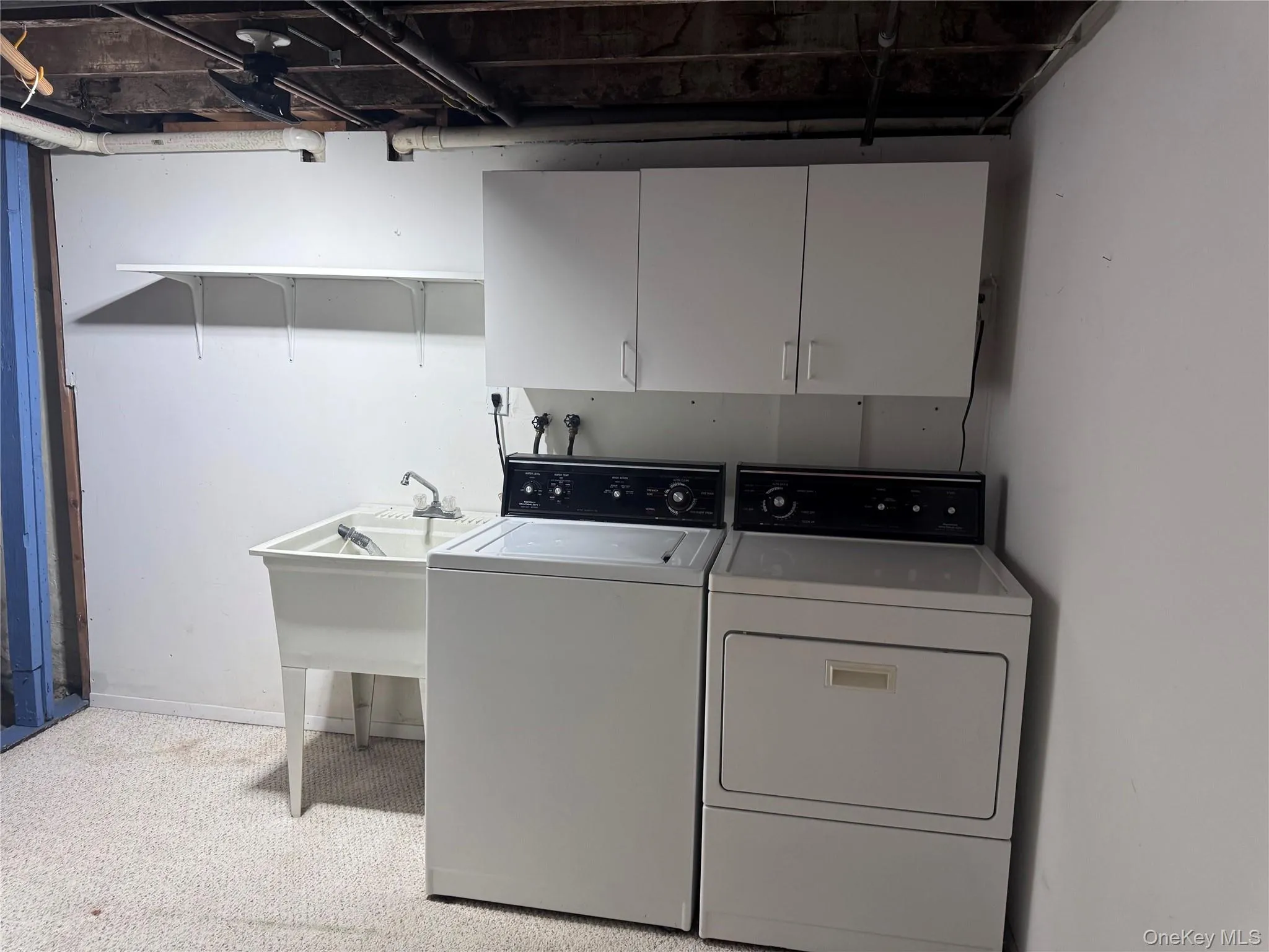 Laundry area with independent washer and dryer and cabinet space Laundry area with independent washer and dryer and cabinet space